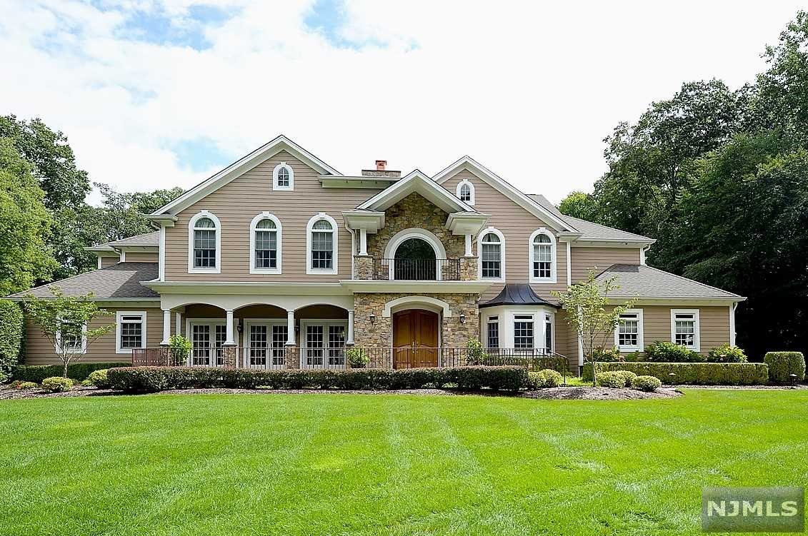 Enter thru the Mahogany front doors to a 2-story foyer with a curved staircase flanked by a banquet sized DR and a lovely LR with a dual fireplace to the great room. The GRT RM, with 18' ceiling and walls of glass, overlooks the resort style property. The expansive kitchen opens to a sun filled breakfast area surrounded by windows. The primary wing includes dual offices, BR with FPL, 2 walk in closets and onyx countertops in the spa like BTH. 1st floor is complete with a gym, FBTH, large pantry, mudroom, PR. The 2nd floor has four generous BR's, 2 marble FBTH's.The magnificent rear oasis includes the Gunite pool, pool side pavilion, surrounded by a 58' Koi pond with 2 streams, 3 waterfalls and 3 bluestone bridges. The patio is complete with an outdoor kitchen and dining areas. A walking path surrounds the rear yard. Attention has been paid to every detail in this custom home. Truly a MUST SEE!!
