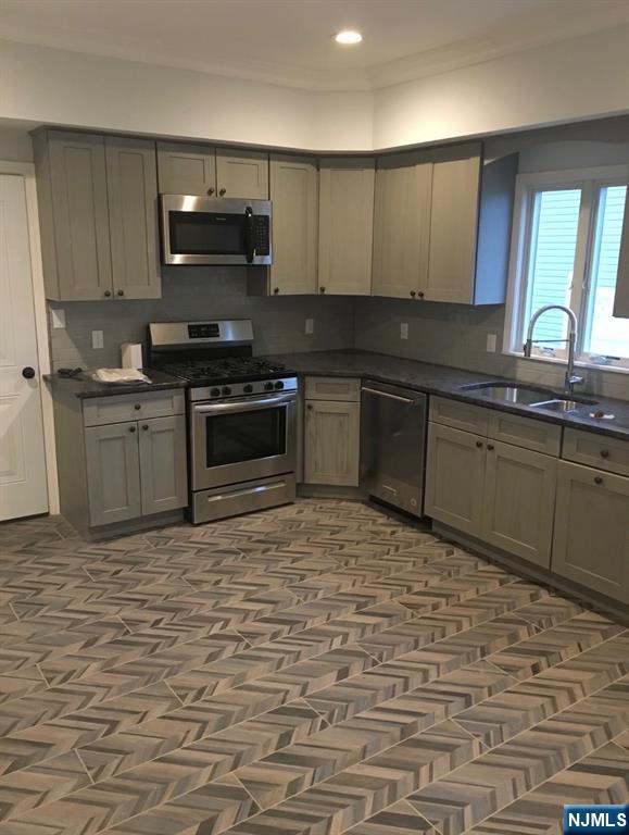 Newer 2 Family Home. Ground Floor with no steps featuring 4 rooms, 2 bedrooms, living room with fireplace, custom kitchen with stainless steel appliances with 1 car garage and half driveway and shared backyard. 1.5 month security +broker fee of 1month; NO PETS. Washer/Dryer Hookup, Radiant Heat and Central Air. For showings or questions contact Maria Scaglione at 201 240 5396