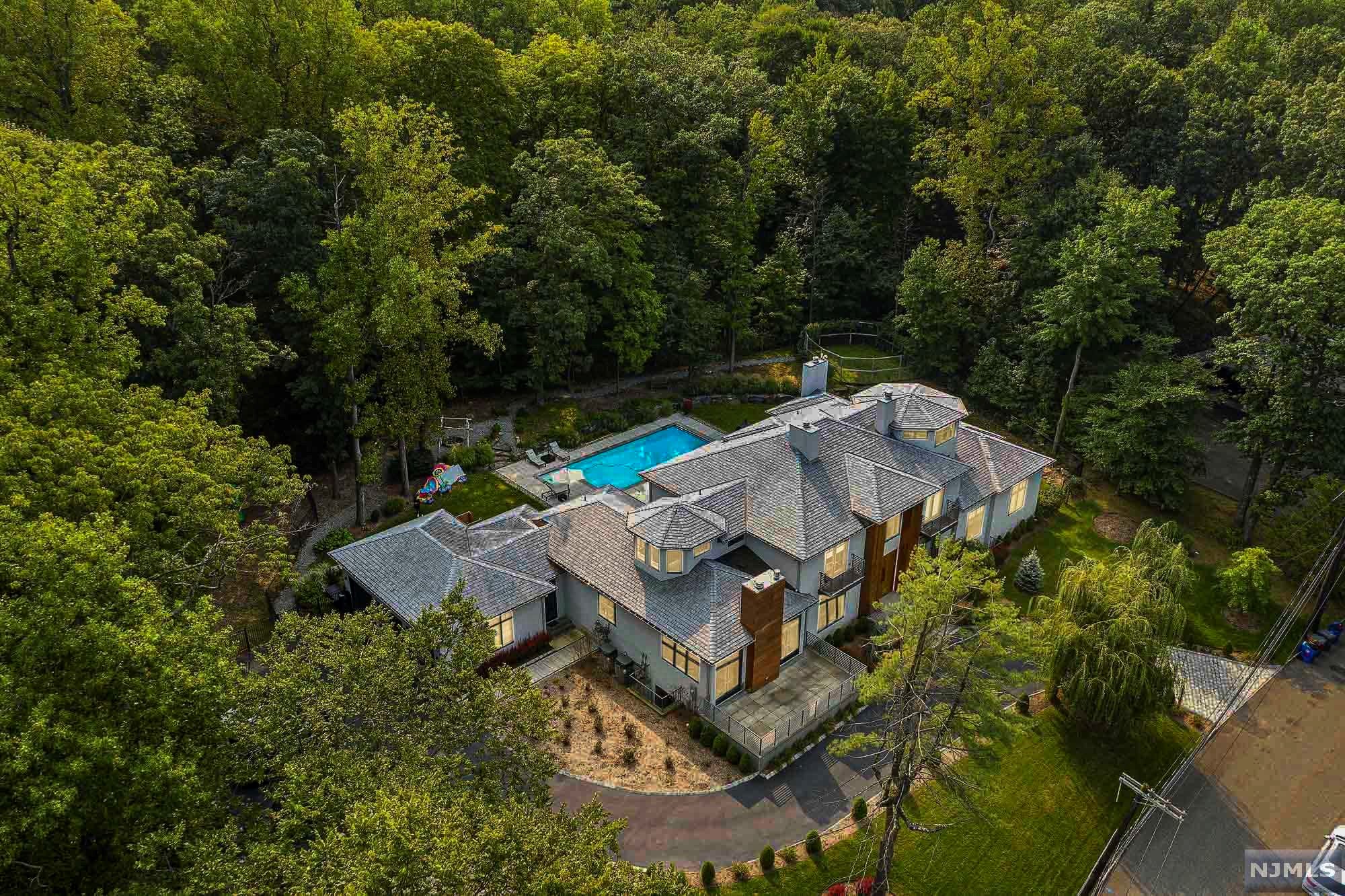 The VIRTUAL TOUR link contains an enormous amount of information including a comprehensive video tour w/ hidden features & room dimensions,additional photos, floor plans, & complete interactive 3D model of the home.With more than 12,600 sqft of living space, this architectural custom built masterpiece on the East hill of Englewood exemplifies both elegance & functionality. 7 en suite bedrooms, each w/ a balcony & luxury Porcelanosa bathroom.Utmost attention to detail is evident throughout this luxury home w/every detail customized. The floor-plan is open & inviting for entertaining w/ 25 ft ceilings, 12 ft mahogany entrance doors, an indoor planter & floating stairs. Other features include radiant heat under all tiles, salt water pool, custom chefs kitchen by Leicht w/ caesar stone countertops, gym, spa w/sauna steam room & smart home Crestron system. Observatory on the 3rd floor is an incredible bonus to this already special home. A spectacular property, only minutes from NYC