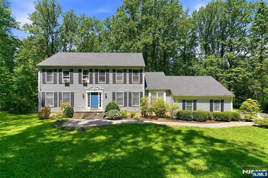 Welcome to 17 Grandview Terrace. This young, modern, and spacious center-hall colonial has it all, catering to a wide variety of lifestyles. Nestled on two quiet acres, the home offers peace and tranquility from the hectic pace of North Jersey life. Enter to a beautiful foyer. On this main level you'll find a light-filled formal living room with French doors leading to the family room with wood-burning fireplace. The eat-in kitchen is the main hub of the home, offering a breakfast bar, eating nook, stainless appliances, and granite countertops. This area offers direct access to the formal dining room, back deck, laundry room, and garage. Rounding out the first floor you'll find a bonus room that can function as an office or guest area, and a powder room. Up to the second floor you'll find a generously sized primary bedroom with en suite bath and huge walk-in closet. This level has 3 additional bedrooms and a stunning full bath with dual sinks, stall shower, and deep soaking tub. The walk-out basement offers amazing additional space, including a rec room, play area, game room with pool table, private bonus room, utilities, storage, and a half bath. Indoor-outdoor living is seamless with a huge deck overlooking the grounds, and ample yard space to play and entertain. Completing the home is an oversized, attached 2-car garage, and extra long driveway with multiple spots for off-street parking.