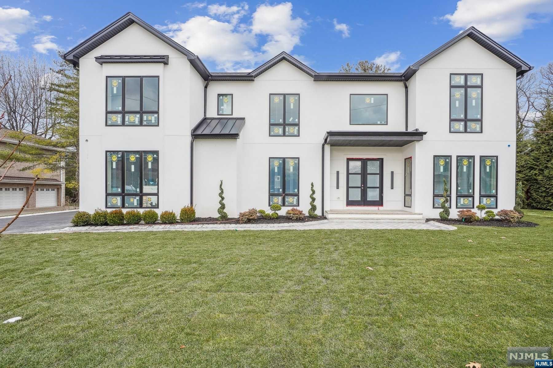 Luxurious new construction in the prestigious North Cliffs area of Englewood Cliffs, NJ. Proximity to NYC for easy commuting, this beautiful home offers opulent yet low-maintenance living. Spanning 5,636 square feet with exquisite craftsmanship and unique features throughout such as stone-wrapped fireplaces, Chef's kitchen, 3 bar/beverage areas, and a heated 3-car garage. The ground level boasts an additional 2,000 square feet with a sprawling 20x40 family room and 1.5 baths. Heated saltwater pool. Great natural light. Unmatched in elegance, the primary bedroom suite includes a large sitting area with a two-sided fireplace and 3 walk-in closets with one measuring 16x13. Four additional bedrooms, five bathrooms, and many functional spaces including formal living and dining rooms, and a library. Every detail has been designed to meet the highest standards of luxury living. This is the ideal home for a growing family or a grown family seeking a comfortable compound.