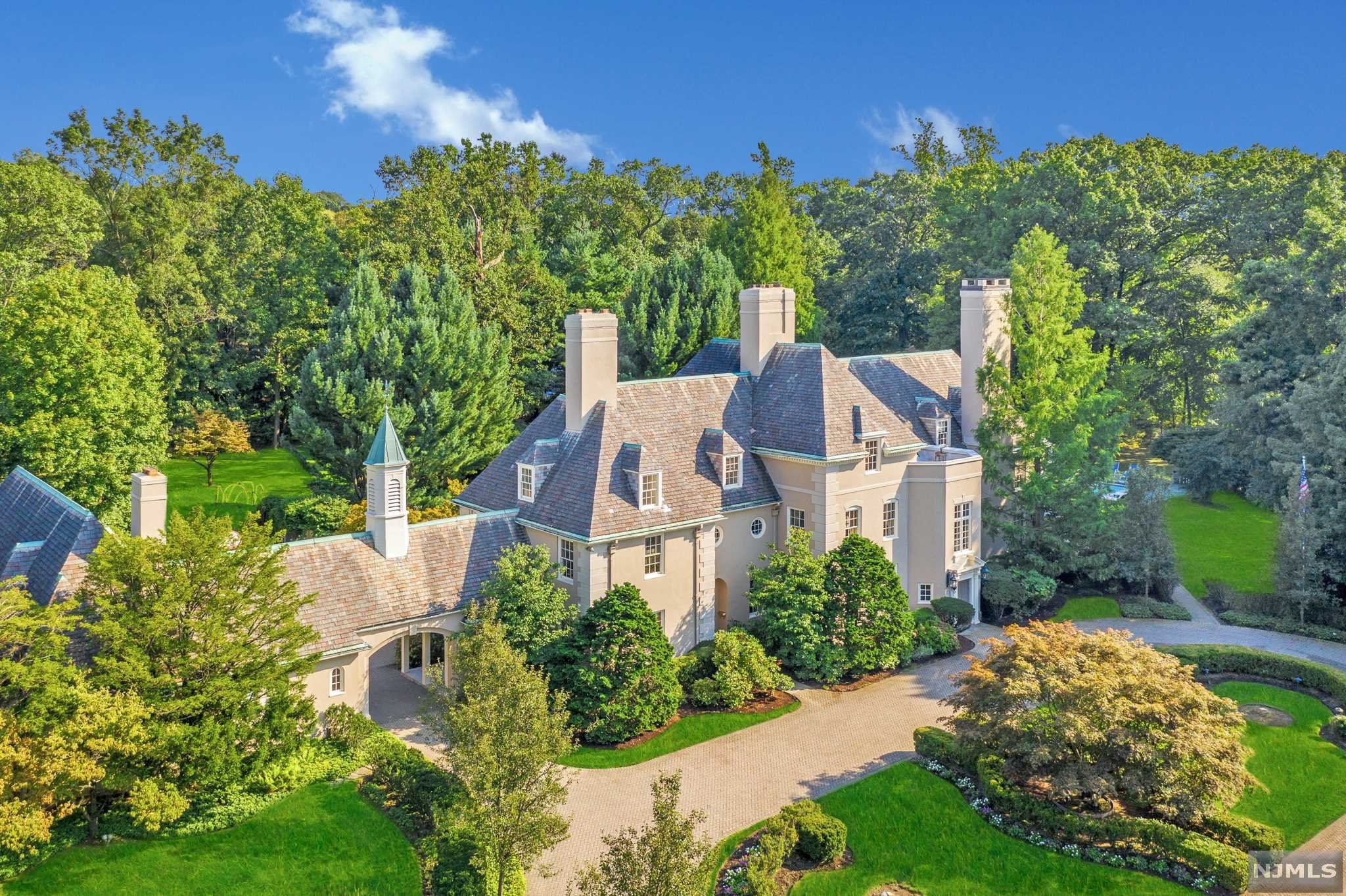 French Chateau inspired mansion, hidden on three park-like gated acres, with meticulous grounds and resort like amenities. The gated entryway is impressive with elaborate herringbone driveway, leading to a 3-story, 20 room residence with approximately 12,000 square feet of living space and additional attached 3 bedroom carriage house. The entry foyer sets the tone for luxury throughout with spectacular rooms for entertaining, yet is also the perfect balance for todays casual family living. Located near a nationally ranked K-12 private school, Englewood's fine shops, restaurants, and only minutes to NYC. This compound will appeal to the buyer requiring absolute privacy, a lover of tranquility, and an appreciation for the finest craftsmanship.
