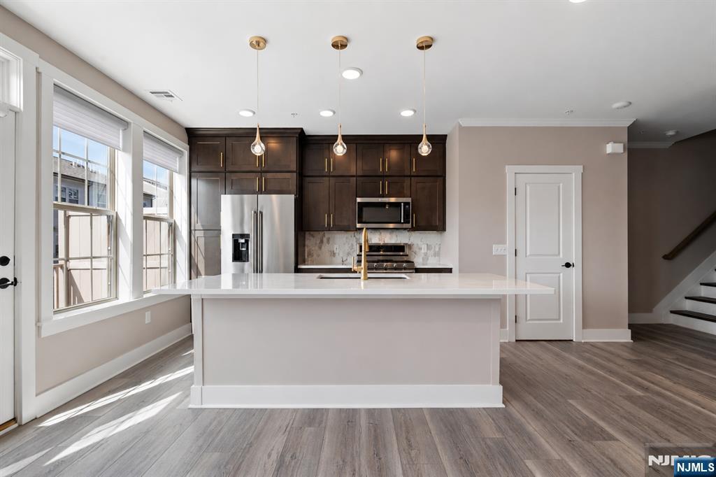 Stop scrolling, this is the one you've been waiting for! Better than new, this beautifully upgraded 2-bed + loft townhome (w/ potential for a 3rd bed) offers 2 full and 1 half baths, 1,771 SF of thoughtfully designed living space & premium upgrades throughout in the highly sought-after LINK at Westmont. Built in 2022, this home stands out with a gourmet kitchen featuring KitchenAid stainless steel appliances, a marble backsplash & an open-concept layout that flows into the bright living area w/ a private balcony, perfect for grilling or relaxing. Custom upgrades include luxury vinyl flooring, designer lighting, upgraded moldings, wainscoting, a custom mudroom bench, finished garage, built-out primary closet, designer accent wall & remote-controlled motorized blinds. Builder enhancements include a spa-like primary bath w/ a tiled walk-in shower, soaking tub, tray ceiling, luxury tile, enhanced HVAC system w/ electronic air cleaner, zone dampener, humidifier, double vanity & garage hose bib. Smart home features include a Ubiquiti network & Guardian security system w/ cameras. Enjoy a tax abatement thru 2027, a structural warranty thru 2032 & outstanding community amenities including guest parking, on-site shops, an athletic complex, dog park, playgrounds, baseball fields, tennis courts, soccer fields, pickle ball courts & convenient access to the Westmont Train Station. Schedule your private showing today & see for yourself why this is the one you'll want to call home!