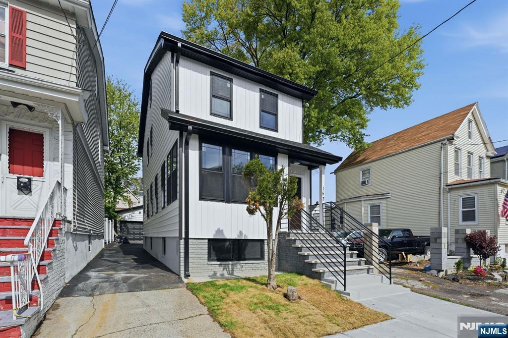 Stunning top notch modern single-family home offering 4 spacious bedrooms and 2.1 bathrooms, plus a finished attic and a fully finished basement. The first floor features a bright formal living room, an elegant dining area and a Beautifully designed kitchen featuring a center island with a built-in microwave space conveniently tucked underneath. sleek finishes and brand-new stainless steel appliances, along with direct access to a rear cozy deck. A convenient powder room and an enclosed front porch provide ideal space for a home office, sitting area, or flexible use. The second floor along with the finished attic offers four generously sized bedrooms and a full bathroom, providing comfort and versatility. The finished basement showcases an open-concept layout, a full bathroom and a dedicated laundry area. This home is equipped with dual-zone central air and HVAC systems for efficient year-round comfort. The exterior features a private driveway, an oversized detached garage and a cozy deck ideal for entertaining and outdoor gatherings. Truly turn-key and move-in ready, conveniently located near NYC transportation, schools, shopping and more. A must-see home that offers the perfect blend of style, space, and functionality!