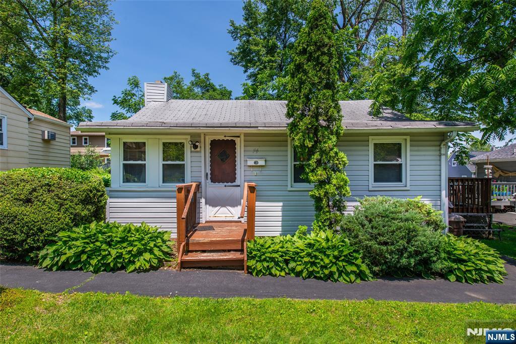 Fantastic opportunity in desirable Upper Lake Hiawatha! This large, level lot offers endless potential perfect for a knock down or a total renovation. Surrounded by homes that have undergone complete renovations or new construction, this property is a true builder's dream. The existing home features a spacious living room with soaring cathedral ceilings and a striking stone wood burning fireplace, an eat-in kitchen with access to the deck, a formal dining room, two bedrooms, full bathroom, and laundry room. Conveniently located close to schools, this property is ideal for those looking to invest, build new, or restore a home with great bones in a prime location.