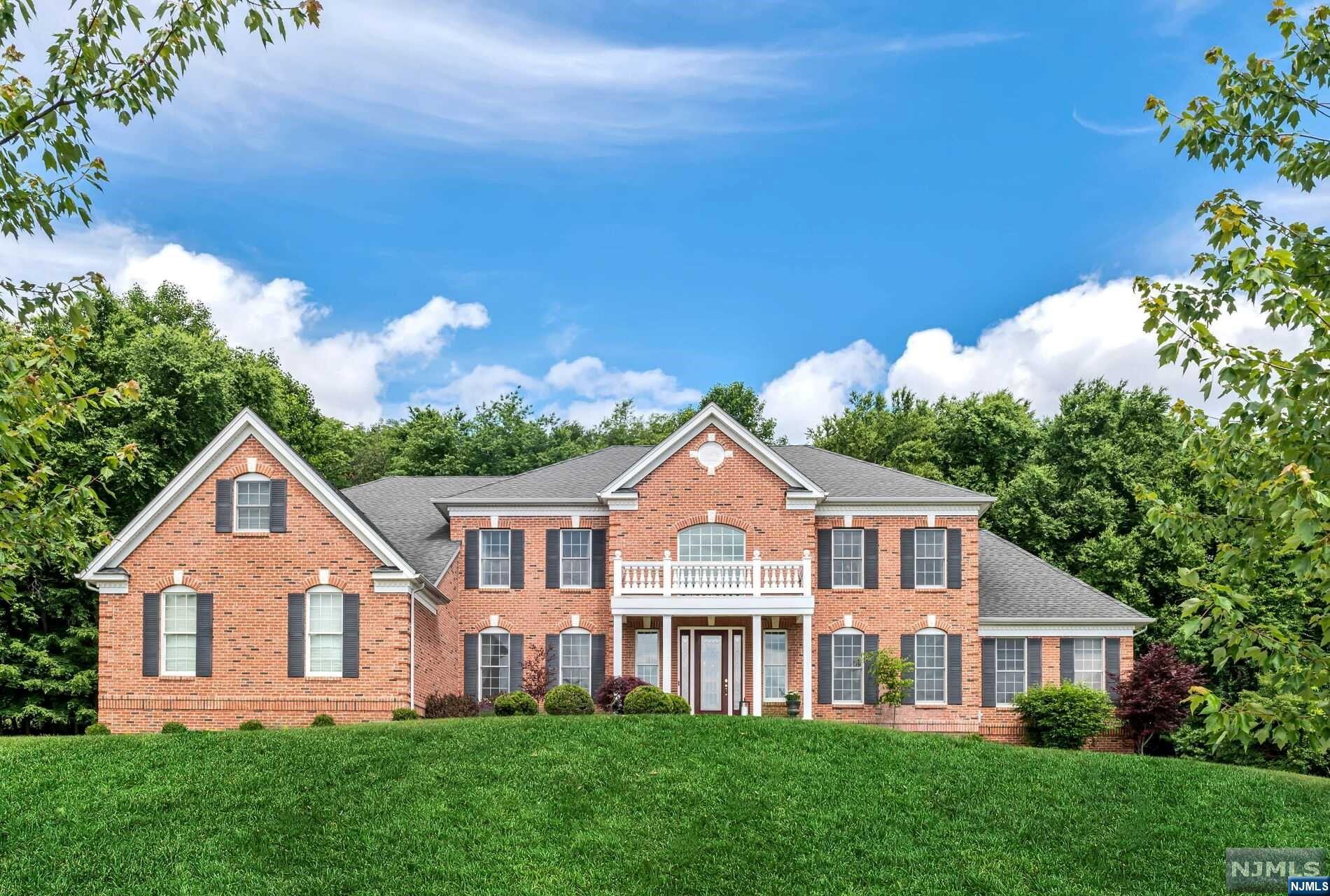 WELCOME HOME to the luxurious lifestyle of your dreams! Stunning and palatial Toll Bros estate home features 5398 sq.ft of comfortable living space within an award winning designed floorplan. PROPERTY TAXES REDUCED due to owner's successful appeal! Breathtaking two story foyer surrounded by living & dining rooms enhanced with butterfly staircases leading to the upper atrium. Two story family room with cozy fireplace, 1st floor study & sunny conservatory. Chef's delight kitchen with breakfast room and bar, walk in pantry, kitchen desk and opens to mud rm & laundry rm. GARAGE ENTRY ON FIRST FLOOR Primary suite features a sitting room, fabulous ensuite bath with Roman jetted tub, dual water closets and two outrageous walk in closets. All secondary bedrooms have their own ensuite baths. Custom designed outdoor kitchen w/1000 sq ft patio. PREMIUM WOODED LOT backs to Black Oak Golf Club! Top tiered schools & only one hour commute to NYC!