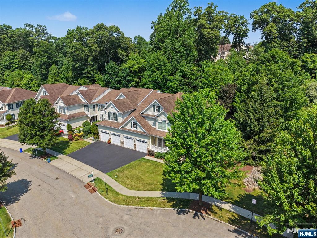 Live at the height of luxury in The Regency at Denville! Ideally positioned at the end of the community on a CulDeSac, this meticulously maintained end unit offers exceptional privacy, abundant natural light & over 3100 sqft of beautifully designed living space. The premium setting backs to preserved forestry with the largest deck in the community, this townhome may be the most desirable locations. HW floors, custom moldings & high ceilings enhance the bright, open interior. The main level features an inviting formal LR & DR that flows seamlessly into the eat in kitchen with Bosch SS appliances. The impressive FR boasts soaring high ceilings & a gas fireplace, creating a beautiful space for everyday living & entertaining. The desirable 1st floor primary suite features high ceilings, a walk-in closet & a spacious ensuite bath with a jetted tub & stall shower. A convenient PR completes the main level. Upstairs, you'll find 2 addtl bdrms, a full bath, a large loft & a dedicated office with built-ins, offering exceptional flexibility for working from home or accommodating guests. The full bsmt is partially finished with a rec room, while still providing plenty of storage space. Central air only 1 year old. Oversized 2 Car Garage and plenty of parking. The Regency offers a private, expansive setting complemented by community amenities including a clubhouse, pool, gym, tennis courts & more, all just mins from DWTN Denville, NJ Transit, shopping, dining & major commuting routes.