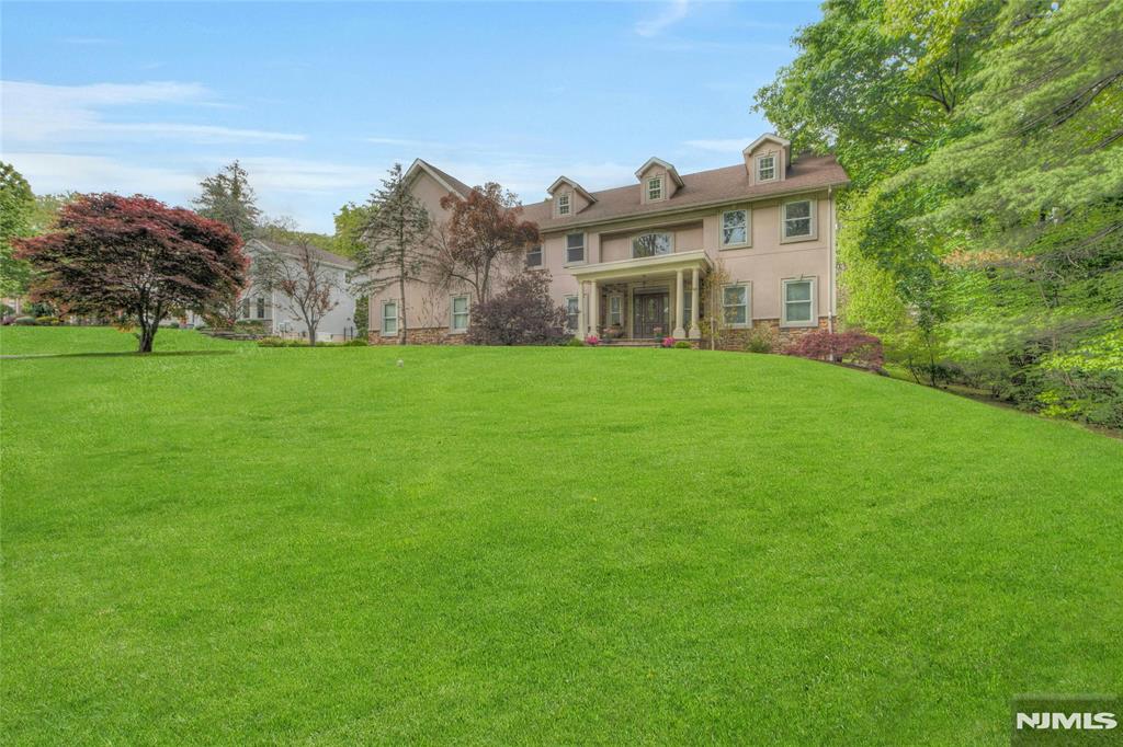 Luxury Executive Estate Steps from Wyckoff Town Center. Discover prestige and modern comfort in this sun-drenched 5-bedroom, 4.5-bath colonial. Perfect for entertaining, the open floor plan features a gourmet kitchen with granite countertops , breakfast bar and top-tier stainless appliances , a breakfast nook,a Great Room with a gas fireplace, and large formal dining room. A rare 1st-floor guest suite adds ultimate convenience. The 2nd level features a massive primary sanctuary with a sitting area, spa-like bath and HUGE walk in closet, plus three additional bedrooms (including a private suite and Jack-and-Jill bath). The fully finished basement adds significant living space and dedicated rooms for a family/TV room, exercise room, and private office, plus ample storage. Complete with a 3-car garage, 6-zone heat, generator and an expansive backyard near schools and shopping.