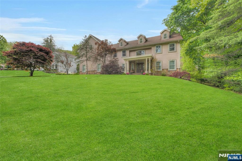 Luxury Executive Estate Steps from Wyckoff Town Center. Discover prestige and modern comfort in this sun-drenched 5-bedroom, 4.5-bath colonial. Perfect for entertaining, the open floor plan features a gourmet kitchen with granite countertops , breakfast bar and top-tier stainless appliances , a breakfast nook,a Great Room with a gas fireplace, and large formal dining room. A rare 1st-floor guest suite adds ultimate convenience. The 2nd level features a massive primary sanctuary with a sitting area, spa-like bath and HUGE walk in closet, plus three additional bedrooms (including a private suite and Jack-and-Jill bath). The fully finished basement adds significant living space and dedicated rooms for a family/TV room, exercise room, and private office, plus ample storage. Complete with a 3-car garage, 6-zone heat, generator and an expansive backyard near schools and shopping.
