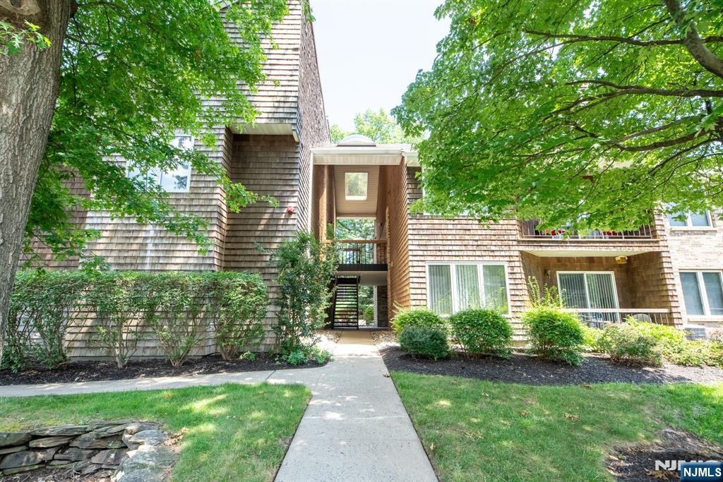Renovated 2-bedroom, 2 full bath top floor unit located in the peaceful and sought-after Tulip Gardens community. This spacious home features luxury flooring throughout, recessed lighting, and an abundance of natural light. The updated kitchen offers granite countertops, ample cabinetry, and stainless steel appliances. The open living and dining area includes a cozy fireplace and sliding doors leading to a private balcony overlooking the courtyard. The primary bedroom includes a walk-in closet and master bath. A second generously sized bedroom and full bath complete the space. Additional features include in-unit laundry, central air, parking and tennis courts. Ideally located near shopping, restaurants, NYC bus service, and a short drive to the train and major highways.