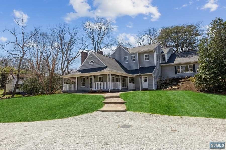 Located on 2.18 acres in the picturesque town of Rockleigh, just 12 miles from the GWB, this beautifully restored farmhouse has been expanded, w/a unique and spacious floorpan. 2 great rooms, one right off the country kitchen w/French doors leading to the wrap around porch, the other tucked away on its own mezzanine level, perfect for a billiard room/ Rec room. Country kitchen w/stone fireplace offers four different access points making it the center of the home. LR w/fpl is private and charming. DR is large and bright. Numerous work from home options. The primary suite is one of 5 BR loc on the 2nd level. (7 BR total). Loft area overlooking FR on second level. 2 addit structures are on the property. Detached 2story gar offers options for private guest quarters or home office. Barn w/hay loft offers multiple options! Generator. New roof! New septic system! Low taxes ! Rockleigh uses the NVHS district which was ranked the best district in Bergen County and #2 in the state!