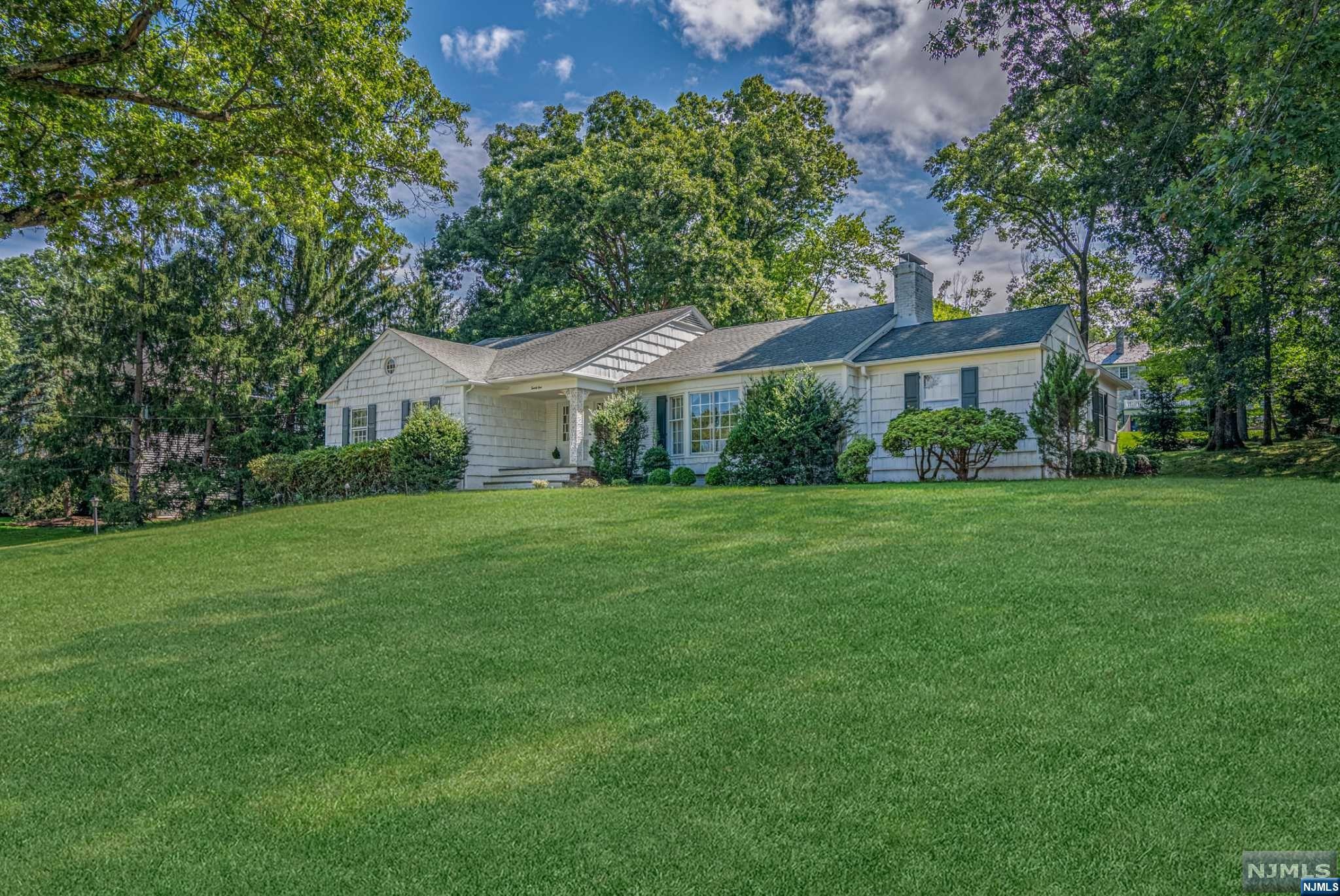 Do not miss this beautiful ranch nestled on one of the most sought-after streets in Essex Fells. Featuring 3 bedrooms 2.5 baths with a large driveway and two car garage. With a lot size of .76. Upon entering the foyer, you will find an inviting living room with a stunning large bay window. Enjoy the amazing warmth of a double fireplace in the oversized living room and family room. There are hardwood floors throughout the house. Spacious dining room for hosting all your gatherings. Eat in kitchen is overlooking the backyard. All bedrooms are generous in size, especially the primary bedroom that includes a walk in closet and full bathroom. Basement hosts cedar closets and tons of space. Top rated schools and spectacular town. Easy access to NYC transportation, restaurants, shops, and stores. Excluded are the washer and Dining room chandelier. New AC unit.