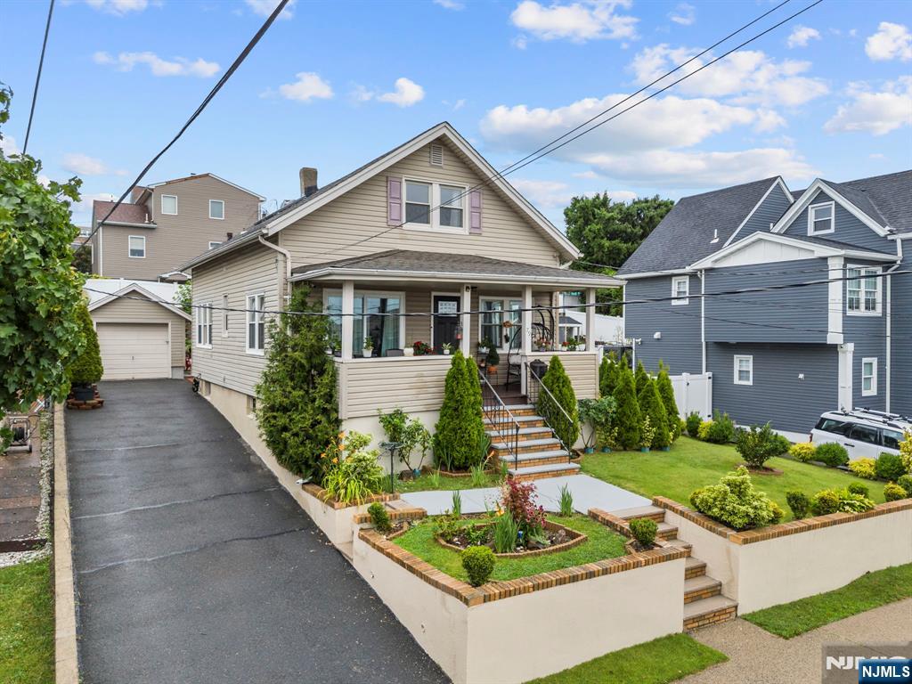 Thoughtfully renovated down to the studs, this exceptional home reflects the quality craftsmanship and attention to detail of an owner who intended it to be their forever home. This 3BRM, 3FBATH home, plus an office/den, offers modern comfort throughout. Every major system, including the HVAC, electrical, furnace, hot water heater, and double-pane windows, is under five years old. Natural light fills every room, while hardwood floors lie beneath the newer laminate flooring. Outside, enjoy a beautifully landscaped yard, a front porch with stunning NYC skyline views, a one-car garage, and parking for four additional vehicles. A large unfinished basement with high ceilings and exterior access offers endless possibilities. Don't miss this rare opportunity to own a meticulously maintained home in desirable Wood-Ridge.