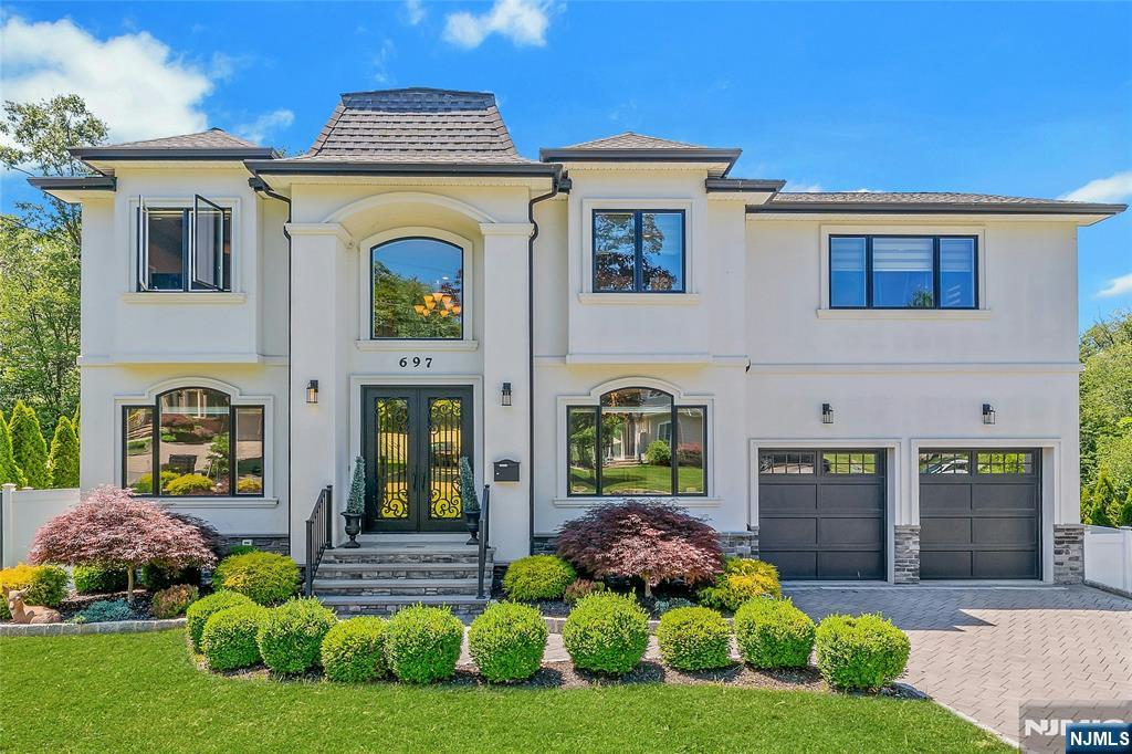 This move-in ready, stunning young colonial showcases over 4,000 sf of luxurious living across 3 levels, including a walk-out lower level and a lot of natural light throughout. Built in 2017, this home offers 5 bedrooms, 4.1 baths, a spacious great room with coffered ceilings, hardwood floors & elegant woodworking, state-of-the-art appliances, and recreation / office space in the lower level. The lot is beautifully-landscaped, with picturesque views from the raised veranda, complete with a full stonework outdoor kitchen and fire pit, while facing a protected wooded area for added privacy. Easily commutable to NYC, with walkable NJ Transit bus access at the end of the block, the property is located near Route 17â€™s desirable retail destinations, and Paramusâ€™s schools, recreational areas, and other community amenities.