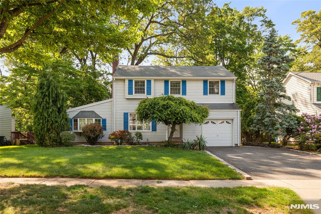 Well-maintained 4 bed, 1.5 bath home tucked away on a quiet street in one of River Edge's most desirable neighborhoods. Set on a beautifully landscaped property & wonderful curb appeal, the backyard borders Van Saun County Park w/ a large natural barrier of mature trees creating a rare, private & peaceful setting. A large 2 tier deck w/ newer French doors creates seamless indoor outdoor flow perfect for entertaining or relaxing. The 1st floor features a formal living room w/ wood burning fireplace, dining room, spacious kitchen & sunroom while creating an ideal layout for everyday living & entertaining. Filled w/ warmth & character throughout, the home features generously sized bedrooms, abundant natural light, hardwood floors, elegant wood trim, freshly painted interior, ample storage, large closets, finished basement providing additional flexible living space & an attached garage. As well as, an updated electrical panel & newer water heater. Conveniently located just 5mins. from the River Edge Train Station & close to Routes 4, 17 & the Garden State Parkway, this home offers easy commuting w/ the NYC bus to Port Authority down the street & the George Washington Bridge less than 9 miles away. Just minutes from highly ranked Roosevelt Elementary & River Dell Middle / High Schools, while also close to Bergen County Zoo, Veteran's Memorial Park, plus shopping & dining along Kinderkamack Rd, The Shops at Riverside Mall, Bergen Towne Center & Garden State Plaza. Don't miss out!