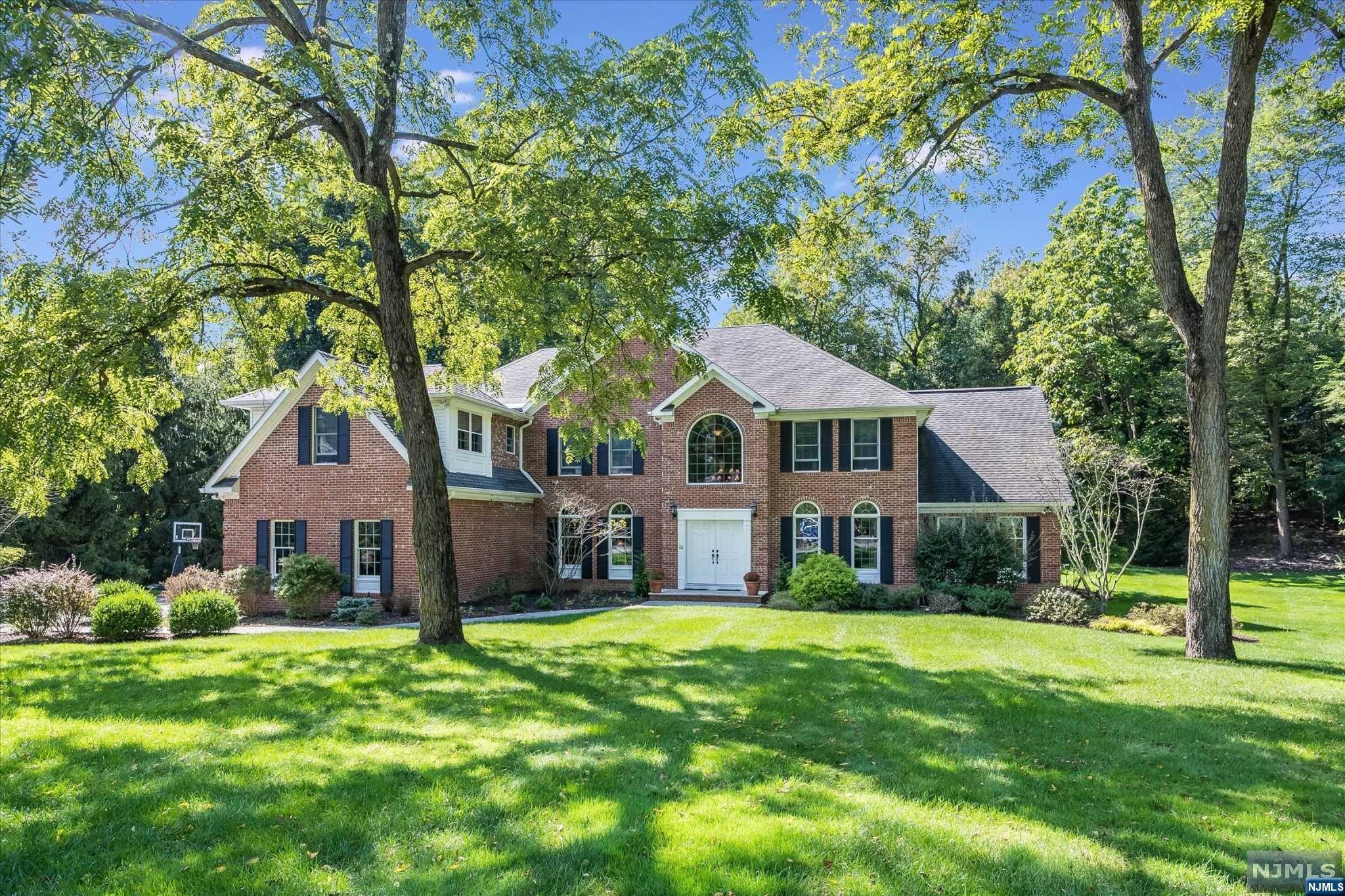 Welcome Home to this stunning center hall colonial in the highly sought after Fardale section of Mahwah! The 4 bedroom, 4.5 bath is located at the end of a quiet cul-de-sac and has over 4,300 sq feet of living space on a beautifully manicured 1.3 acres. The first floor has a wonderful flow for entertaining and everyday life and features a large gourmet kitchen, formal dining room, private office, sitting room, mudroom w/laundry, powder room, a stunning great room, and a sun room w/cathedral ceilings and a built in bar. Upstairs features a gorgeous primary suite, complete with dual walk-in closets and master bath, 2 additional en-suite bedrooms, an additional bedroom, and a loft space/2nd home office. Large finished basement offers so many possibilities and includes a full bath, kitchenette, and tons of storage. The showstopper blue-stone patio is complete with built-in grill, fire pit and is truly a STUNNING space to entertain. A beautiful "home" in every sense of the word!