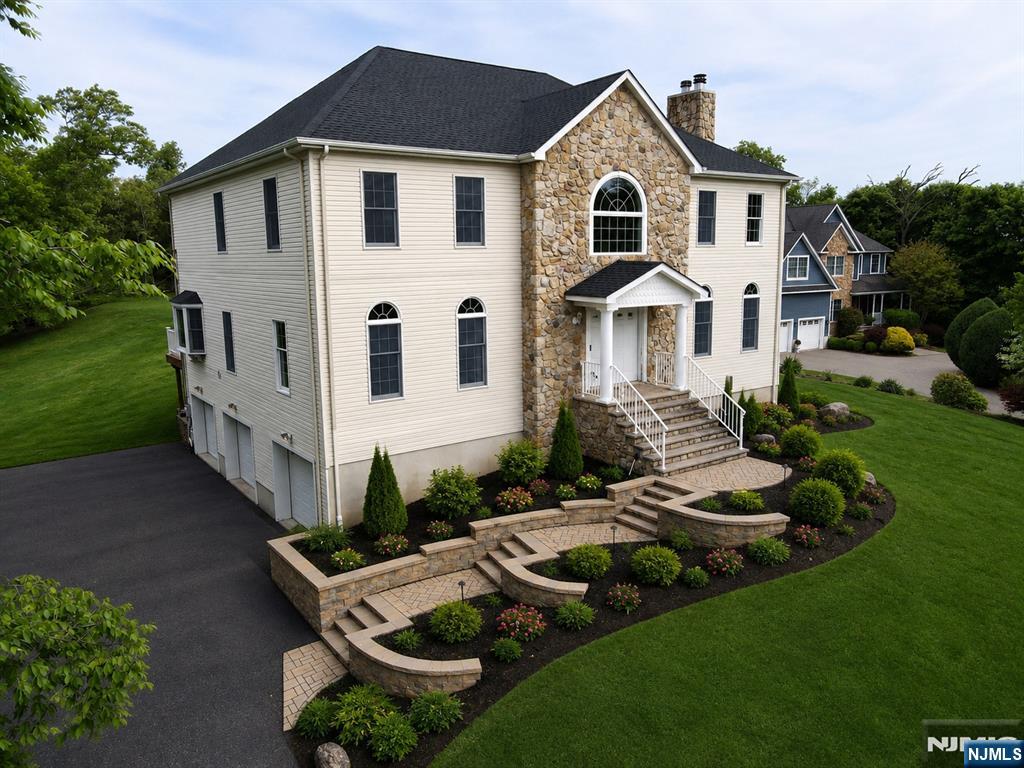 Welcome to this beautifully updated Colonial offering space, style, and modernized upgrades throughout. A newly paver walkway leads from the front door to an oversized driveway and three-car garage, setting the tone for whatâ€™s inside. This home features a brand-new custom kitchen with stainless steel appliances, fresh paint throughout, gleaming hardwood floors, a new roof, and newly updated central air. A welcoming foyer greets you as you walk through the front door and leads into a spacious living room and versatile family room or study with a wood-burning fireplace and stunning custom built-in bookshelves complete with a rolling ladder. A powder room and formal dining area complete the main level. Upstairs features four generously sized bedrooms, including a primary suite with two walk-in closets and a private bath with a jetted tub, stall shower, double vanity, and linen closet. An additional full bath with updated vanity serves the remaining bedrooms. Enjoy outdoor living on the new Trex deck overlooking a large, private backyard with endless possibilities. The full, unfinished basement offers excellent potential for future living space. Set in a highly sought-after neighborhood, this home offers peace, privacy, and natural surroundings while remaining conveniently located near top-rated schools, shopping, dining, major highways and NYC transportation.