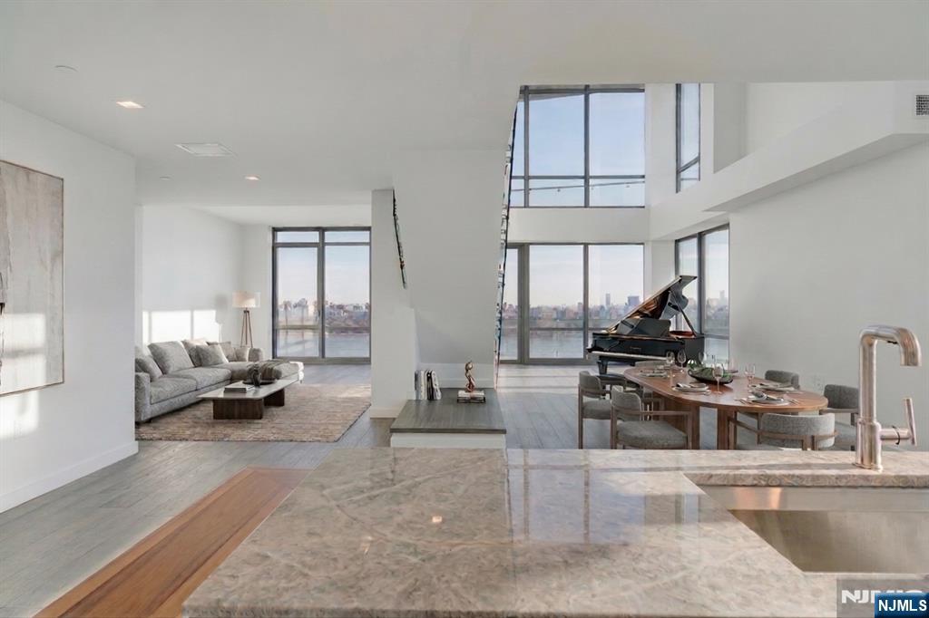 Stunning 3-Bedroom, 4-Bath Duplex with Panoramic NYC Views at One Park Condos Experience luxury living with sweeping, unobstructed views of the Manhattan skyline and Hudson River from this sophisticated two-level residence at One Park Condosâ€”one of North Jerseyâ€™s premier full-service buildings. A residence of this size with these views along the Hudson River is truly rare. This thoughtfully designed duplex offers a modern open layout with one bedroom on the first floor and two additional bedrooms on the second level. The home features two spacious primary suites, each with spa-like bathrooms, 7â€ white oak hardwood floors, and refined designer finishes throughout. Floor-to-ceiling windows capture iconic NYC views and fill the space with natural light. The gourmet kitchen is appointed with Thermador Pro Series appliances, Cielo Quartzite countertops, and custom white lacquer cabinetry. A private balcony extends the living space, ideal for skyline sunsets, with motorized shades for comfort and privacy. Residents enjoy resort-style amenities including a 24/7 concierge, indoor pool, and state-of-the-art fitness center, all just minutes from Manhattan. Call today for your tour.