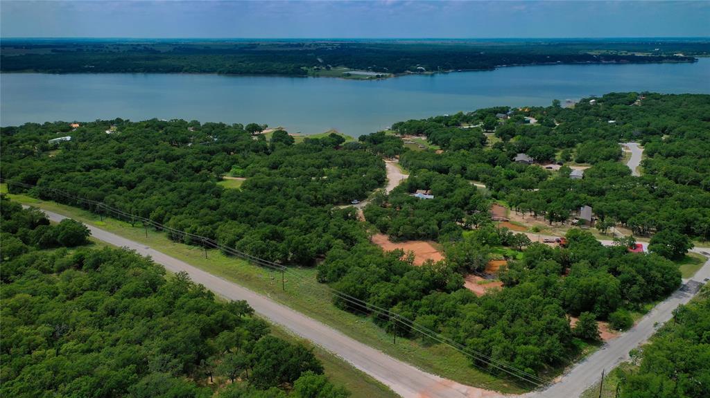 Three good size building lots tucked among shaded tree coverage. Country life with simpler ways awaits your decision. Roomy lots for the home & a place to build a shop. Lake Nocona is within an old saying “as crow fly’s” view. The location of the boat ramp to these lots is ideal. Pack some snacks, lawn chairs, beverages & stroll over to enjoy some family time under the trees, go swimming off the dock, take the boat or watercraft on the lake & make a day of it. Golf carts are the means of transportation which makes things easier. Need a quick meal check out Bears Café at the gate. The community offers golf, air strip, camping, fishing, & security at the gate. Pleasant drive to Nocona for needed items. Shop around downtown, grab a good meal at one of our local restaurants which will always include some good conversation with the locals. Check the calendar for the seasonal events that you won’t want to miss. Stop by one of the wineries in the surrounding area or slip across the river bridge to enjoy one of the Oklahoma Casinos. Who said small communities aren’t happening places. This rural area proves to be a good time. Coming soon will be the newly remodeled Clubhouse, 19th Hole, Pro Shop, & with fingers crossed incorporate some golf tournaments if that is possible. Lots of positive turn-a-rounds for the HOA in recent coming dates. Access with an agent only. A new survey will need to be completed to determine exact lot size & boundaries. 

There are 3 groups of lot opportunities to purchase and if more privacy or space is needed there is a total of 10 lots that can be purchased as a bundle. Pick your group, settle on it, & make this happen!