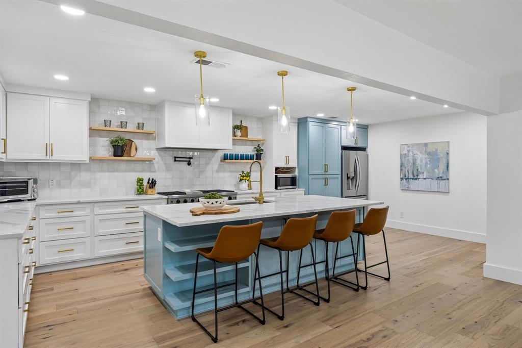 Tucked away on a quiet cul-de-sac in North Dallas, 6505 Beckwith is the kind of home that rarely checks every box. This property is fully renovated, thoughtfully designed, and built for both everyday living and effortless entertaining. Every inch of this home has been reimagined with clean, modern finishes, soaring ceilings, and an open-concept layout that feels bright, functional, and inviting from the moment you walk in. The kitchen truly anchors the home, featuring an oversized quartz island, custom soft-close cabinetry, a 48-inch THOR gas range with pot filler, and not one, but three separate beverage and bar areas complete with dual wine and soda coolers. Whether you’re hosting a crowd or managing a busy weeknight, the flow of this home just works. Vaulted ceilings, rich wood flooring, and architectural details throughout create a warm, elevated feel while still feeling comfortable and livable. And beyond the cosmetic updates, several major mechanical improvements have already been completed, including new water heaters, new upstairs HVAC, french drains, and a roof replaced in 2022. The floorplan offers the flexibility today’s buyers are looking for. The downstairs primary suite is privately tucked away and feels like a true retreat with a beautifully updated spa-inspired bath. A second downstairs bedroom currently functions as an additional living space and guest suite with easy access to a full bath. Upstairs, you’ll find two additional bedrooms, an updated full bath, and a bonus flex space perfect for a home office, nursery, gym, or playroom. Outside is where this property really shines. The backyard was designed for entertaining without sacrificing usable yard space — a rare find at this price point. Enjoy a sparkling pool, expansive patio areas, firepit lounge space, and low-maintenance turf that gives you the best of both worlds: pool + yard. Modern, functional, and move-in ready in one of North Dallas’ most established neighborhoods.