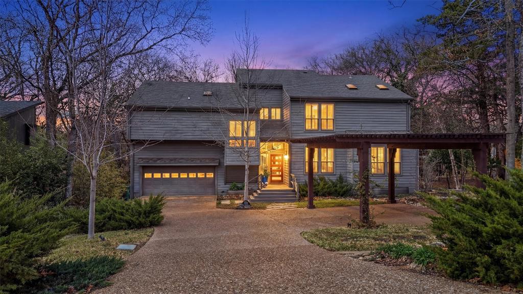 Experience comfortable lakeside living in this inviting Lake Texoma residence, perfectly positioned with multiple neighborhood access points to the water and an easily accessed sandy beach just steps from your backyard. Adjacent to Army Corps of Engineers property, the home offers a unique sense of privacy and peacefulness, surrounded by mature shade trees and scenic views. The tree-lined lot provides a tranquil setting, offering natural beauty and seclusion for relaxation or recreation throughout the year.
This spacious home features 4 bedrooms and 3 full bathrooms, providing flexibility and comfort for a wide range of lifestyles. The generous 2-car garage includes a dedicated mechanical room, plus extra space with a shower—ideal for rinsing off after beach outings. Outdoor living is at its best with a screened porch off the kitchen, patios off both the bonus room and the primary bedroom, and expansive multi-level decks that overlook the beach and surrounding greenspace. Pergola-covered parking offers extra parking convenience.
Inside, you’ll find a light-filled living area anchored by a soaring windows that frame beautiful views, creating an uplifting atmosphere for gatherings or daily living. The chef’s kitchen is outfitted with a propane cooktop and double oven, making meal preparation a delight for culinary enthusiasts. The upstairs primary suite opens to its own private deck, offering a serene spot to enjoy the cove, while an additional bedroom off the bonus room boasts its own deck and cozy reading nook—perfect for relaxing with a favorite book.
Enjoy the peace and privacy provided by thoughtfully designed screens and tree cover, all while soaking in glimpses of tranquil water through the foliage. With easy access to the beach, proximity to Corps land, and outdoor spaces for entertaining or unwinding, this property embodies the perfect blend of luxury, comfort, and natural beauty. Schedule your private tour of this gem and discover all it has to offer!