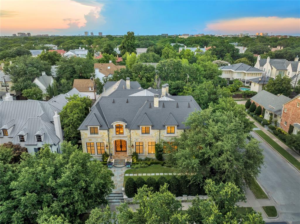 Start making memories here. The house behind the hedges at 3500 Dartmouth Avenue offers a world of possibilities. It delivers both a grand statement for entertaining and the irresistible charm of a family dream home. Set on a wide corner lot on 99 x 150-feet in an ideal location, the property is a golf cart jaunt to the Dallas Country Club and a five-block sprint to the Katy Trail. A custom manse built by Hawkins-Welwood, the house is in pristine condition and loaded with wow factors such as putting green, gardens, pool, fountains, fireplaces, patios, dog run, game rooms, formals, music rooms, live-in suites, turfed yard plus screened doors that swing with the fun of every season. The amenities provide the perfect setting for everything from teen hangouts to toddler tea parties to alfresco cocktails. The sweeping spaces carry a signature of architect Robbie Fusch, whose chateaus and manors are highly praised. Furnishings glow under the tasteful hand of HGTV Design Star Leslie Ezelle.