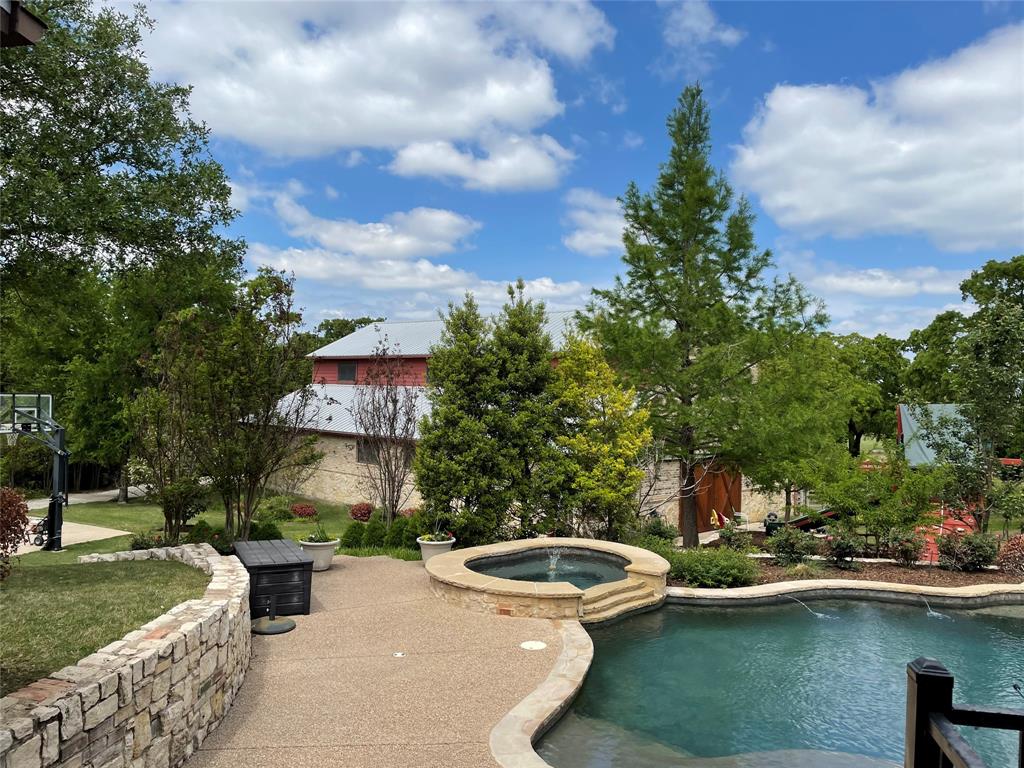 Wow!! Nearly 2 acres nestled on a quiet cul dec sac in Westlake. Come home to a dream. Private gate. Circular driveway. Stunning home and landscaping with heated pool and spa. Unbelievable 3400 square ft. barn with guest quarters up. Downstairs is an AC shop, two stalls plus tack storage and an automotive area with RV+ height garage door. This home has it all tankless water heaters, fire sprinkler system, sweeping views, heavily treed. All of it built with an 81 pier and beam quality foundation. 3 of the four bedrooms on the main floor. Guest quarters has kitchenette, full bathroom, laundry, murphy bed and living area. Truly one of a kind!!