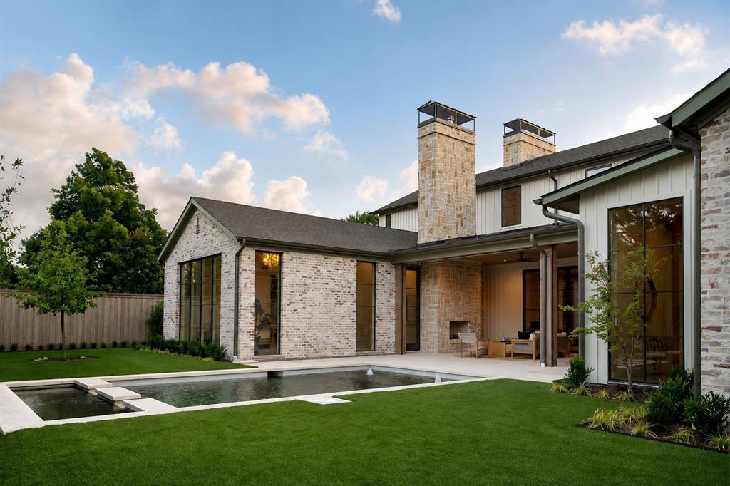 Exceptional new construction by Fifer Custom Homes in the heart of Preston Hollow. Showcasing thoughtful design philosophy + elevated finish selections, this residence pairs timeless architecture with a floor plan tailored for modern living. Spanning 5 bedrooms, 5 full baths + 2 half baths, the home is defined by its seamless flow, generous proportions + abundance of natural light. The chef's kitchen anchors the main level and features custom cabinetry, SubZero Wolf appliances + double islands that overlooks the living and dining rooms, creating an ideal setting for both everyday living and effortless entertaining. The first-floor primary suite is thoughtfully positioned for privacy and serves as a true retreat with spacious dimensions, a spa-inspired bath, washer dryer hookup + beautifully trimmed walk-in closet. A separate 1st floor guest suite offers equally private accommodations for visitors or multigenerational living. An oversized home office is tucked away from the main living areas, providing a quiet and productive work-from-home environment. Upstairs, a spacious game room is complemented by an additional den and versatile flex space that can easily serve as a fitness room, media room, study area or second office. A second utility room adds convenience and functionality to the upper level. Designed to maximize indoor-outdoor living, walls of glass open to a covered patio equipped with automated screens, creating a comfortable outdoor living space that can be enjoyed throughout the year. The backyard is centered around a resort-style pool and enhanced by low-maintenance turf, offering ample space for entertaining, recreation and relaxation. Situated on one of Preston Hollow's most desirable streets, this exceptional property offers convenient access to Dallas' premier private schools, fine dining, shopping and entertainment. A rare opportunity to own a thoughtfully crafted home by one of Dallas' most respected custom builders.