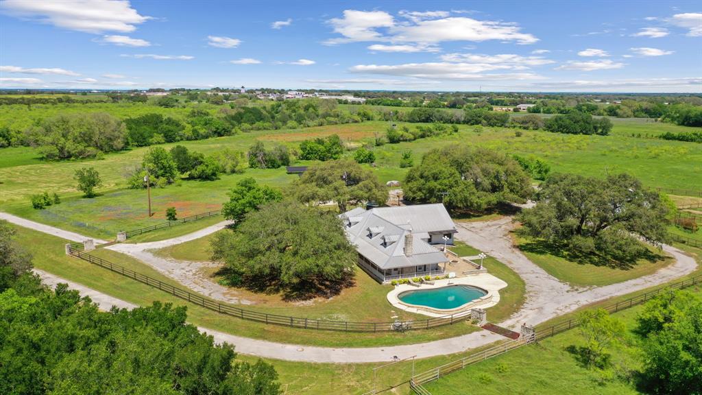 Stunning 77-acres with majestic 300 year old oak trees. Whether you envision building your dream home from the ground up or restoring the farmhouse that already graces the land, the possibilities are endless. One of the most captivating features of this property is the breathtaking creek that meanders along the eastern boundary. With its crystal-clear waters & towering 30-foot cliffs, it's a sight to behold. Spend your days full of adventures exploring its banks. In the springtime, the fields come alive with blue bonnets & Indian paintbrushes. Build your dream horse facility or simply let your livestock graze amongst the lush pastures. The property features a 4 stall barn, workshop, RV-trailer Garage, & 1Bed 1Bath bunk house. Conveniently located between the historic downtowns of Granbury & Weatherford, you'll have easy access to shopping, delectable dining options, & cultural attractions. The Silverado on the Brazos Cutting Horse Arena is just a stone's throw away.