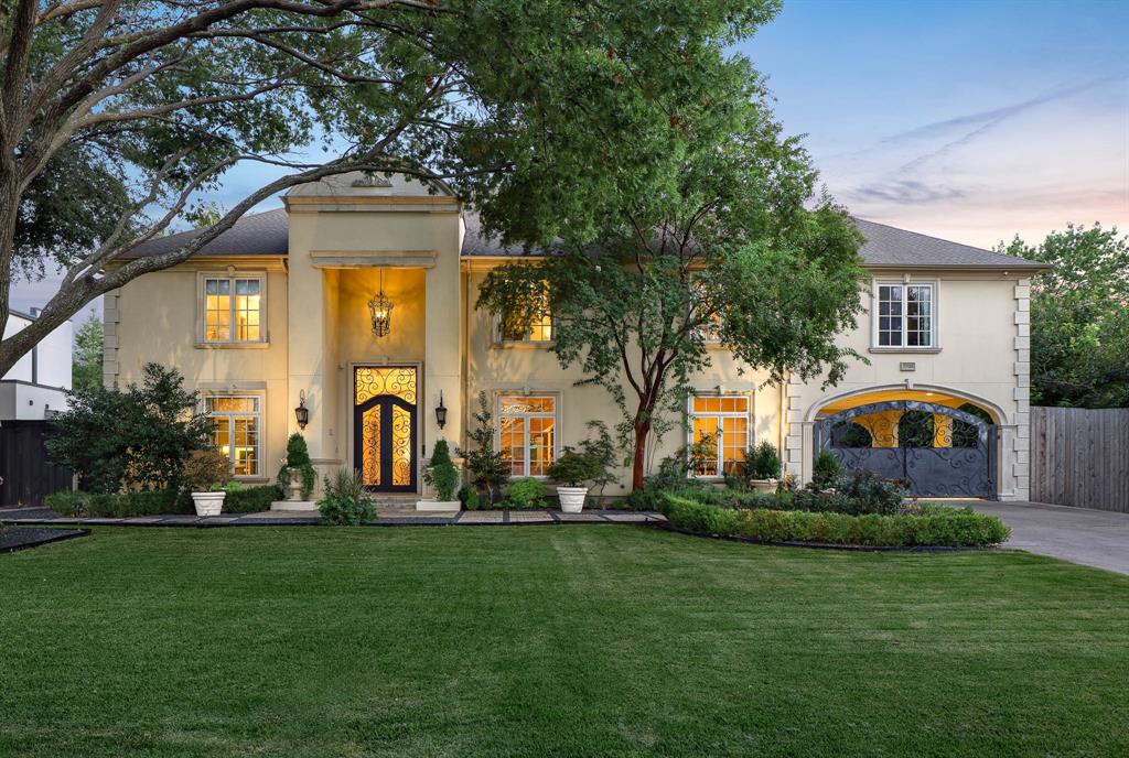 Commanding attention from the moment you arrive, this exceptional Preston Hollow residence offers a rare blend of elegance, space, and architectural craftsmanship. Nestled on a beautifully manicured 152' x 105' lot, this impressive home features 6,223 square feet of luxurious living, with 5 bedrooms, 4 full bathrooms, 2 half baths, 3 living areas, 2 car garage and a 2 car covered porte cache. Grand iron doors welcome you into a striking entryway with soaring ceilings, flanked by a private study and a formal living room that seamlessly flows into the dining room—perfect for entertaining. A sweeping iron staircase anchors the open-concept design, connecting the dramatic family room with the spacious kitchen and breakfast area, all bathed in natural light. A butler’s pantry connects the dining area to the gated motor court, adding convenience and a touch of old-world charm. The gigantic first-floor primary suite is a private retreat, offering serene views of the pool area. The spa-like bathroom features a soaking tub, large walk-in shower, dual dressing vanities, and a fantastic custom closet. Upstairs, you’ll find four generous bedrooms, a reading-study room, a media room, and a huge laundry room. The spacious balcony overlooks the backyard oasis and includes a spiral staircase that leads directly to the lush lawn and resort-style pool. The outdoor living spaces are a true showstopper, featuring a gorgeous pool accented with dramatic firepit bowls, creating a breathtaking ambiance. The oversized pool house includes a fireplace, covered entertaining area, and open sun space, ideal for both intimate gatherings and large-scale entertaining. This is truly a one-of-a-kind home in one of Dallas’ most prestigious neighborhoods—offering privacy, luxury, and the ultimate in timeless sophistication.