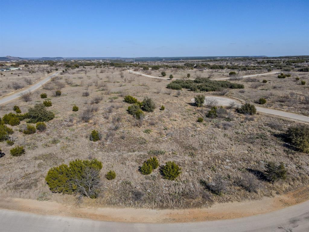 Build your dream home on this .33-acre lot in one of Possum Kingdom Lake’s premier gated communities, featuring a 24-7 guarded entrance. Property owners enjoy 36 complimentary rounds of golf per year along with access to outstanding resort-style amenities, including a marina, boat ramp, community dock, swimming pool, fitness center, clubhouse, on-site restaurant, and tennis courts. With parks, playgrounds, and scenic surroundings throughout the community, this property is ideal for a full-time residence or weekend retreat at Possum Kingdom Lake.