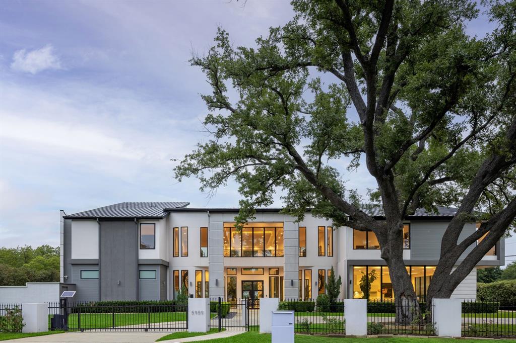 A Contemporary Estate That Redefines Luxury Living Set behind private electric gates in the heart of Preston Hollow, this striking modern estate blends bold architecture with everyday comfort. Thoughtfully designed for both large-scale entertaining and relaxed family living, the home pairs clean, contemporary lines with warm, natural finishes throughout. The grand entry makes an immediate statement, featuring soaring ceilings, expansive walls of glass, and a sculptural staircase that captures attention from the moment you arrive. Sunlight fills the open living spaces, which flow effortlessly from one room to the next, anchored by a dramatic floor-to-ceiling fireplace. At the heart of the home, two fully equipped kitchens elevate both daily living and entertaining—a stunning chef’s kitchen complemented by a separate catering kitchen for seamless hosting. A private elevator, four-car garage, and flexible layout add ease and functionality without sacrificing style. Outdoors, the property becomes a private retreat. A resort-style pool and spa are framed by bold architectural elements and lush landscaping, while the covered outdoor kitchen and lounge invite gatherings that carry well into the night. Upstairs, spacious bedroom suites and a tranquil primary retreat offer privacy and relaxation, along with additional living areas designed for work, leisure, and connection. Every detail of 5959 Colhurst has been carefully considered, delivering the essence of Preston Hollow living—modern elegance, timeless design, and a home that feels as exceptional as it looks.