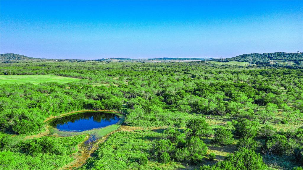 This mostly wooded 642 acre property is rugged in areas and has overall elevation changes more than 100 ft.  It has great potential for hunting, grazing, fishing, family recreation, building your dream home or weekend ranch.  There is enough land to do all those things, and more! 

There are several small ponds scattered throughout the property, providing water for livestock and wildlife. The thick cover of oak, mesquite, and cedar provide great cover for whitetail deer and wild hogs, while the diverse habitat also supports turkey and dove.  
Situated on a gravel county road, the property provides frontage and gate access on two sides, which could allow for the property to be split into two parcels by its new owners.  There is approximately 950 feet of road frontage along the NE boundary, with an additional 1500 feet of frontage along the south boundary.  There is a secure gate for entry at each road frontage location. 

Electric service runs across the northern portion of the ranch, and one meter is currently in place, utilized by the hunters who lease the property.  The hunting lease will be terminated upon the sale of the property and the rustic hunters’ cabin may or may not be removed by the hunters.

Native grasses are abundant and have supported cattle grazing over the years.   The 5.4 mile perimeter of the property appears to be fully fenced, with fences being in fair to good condition. Cross fences are very old and mostly poor condition with many voids.  

The current ag exemption provides significantly reduced property taxes. Estimated at $1,114 for 2025 per Jack Co.

There are wind turbines visible from the property, but none exist on the property.  A solar farm is being developed to the south of the property.  No leases or lease options pertaining to wind, solar, or oil & gas currently exist on this property.  Sellers do own some mineral interests which may be negotiated for conveyance, added to the selling price.

Priced at $6500 per acre!
