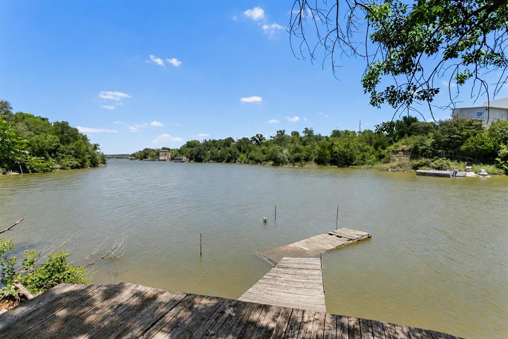 An extraordinary opportunity to build a legacy waterfront estate on one of Lake Worth’s most desirable stretches of shoreline. Tucked beneath a canopy of majestic oak trees, this exceptional lakefront property offers sweeping panoramic water views, unmatched privacy, and a setting that captures the beauty of North Texas lake living.

Owner financing available w.a.c. and significant down payment, making design-build an easy process!

The homesite has been thoughtfully cleared and is ready for construction, allowing you to immediately begin creating a custom luxury residence tailored to your vision. With an expansive building envelope and generous waterfront frontage, there is ample space to design resort-style outdoor living areas, an infinity-edge pool, lush landscaping, entertaining terraces, outdoor kitchen spaces, and private lakeside retreats.

Wake each morning to sparkling water views and enjoy spectacular sunsets over the lake from your future dream home. Despite its peaceful waterfront setting, the property offers exceptional convenience with quick access to Loop 820, premier shopping, fine dining, entertainment, and major employment centers.

Luxury lakefront parcels of this quality and location are increasingly rare. Whether envisioned as a private family compound, a modern architectural masterpiece, or an elegant waterfront retreat, this remarkable property presents a once-in-a-generation opportunity to create an exceptional lifestyle on the shores of Lake Worth.