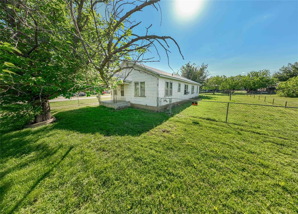 Situated on a spacious corner lot this cozy 3 bedroom, 1 bath property offers great potential for first-time home buyers or anyone looking to add their personal touch. A total of 1,352 sq ft of living space along with a spacious yard makes this property the perfect fit. Step onto the covered front porch, ideal for relaxing mornings or evening unwinding.  Inside you will find a comfortable living area, three bedrooms with plenty of natural light and a full bath. The kitchen offers ample space and opportunity for updates to match your style. Outside, the large fenced in yard provides sufficient room for outdoor activities, gardening or future improvements. A chain link fence adds convenience for pets or added security. Whether you are looking for an affordable starter home or your next investment project, this property is full of possibilities. Schedule your showing today!