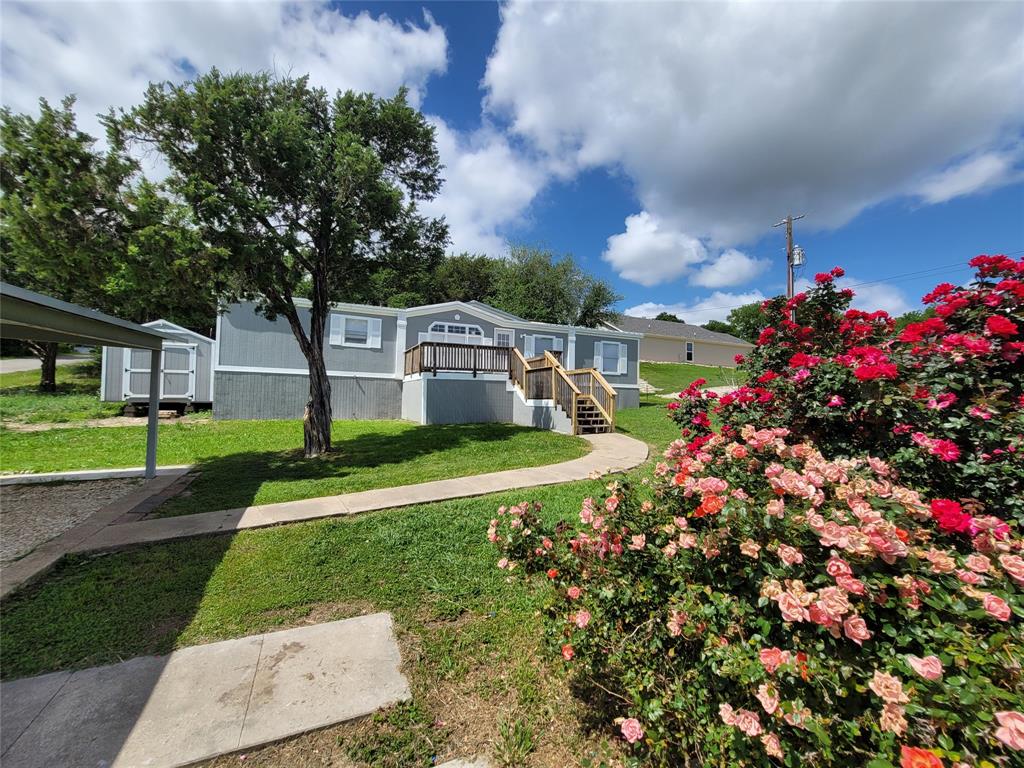 Here is an excellent opportunity to enjoy relaxed lake-area living with extra space and great community amenities. Situated on three lots in the desirable Comanche Cove community, this 3-bedroom, 2-bath, a spacious office double-wide home offers 1,568 square feet of comfortable living space with room to spread out both inside and out. Whether you're looking for a full-time residence, weekend retreat, or investment opportunity, this property checks all the right boxes. Inside, you'll find a functional layout with a spacious living area, generous kitchen, and well-sized bedrooms designed for comfortable everyday living. The primary suite offers privacy and convenience, while the additional bedrooms provide flexibility for guests, family, or a home office. Step outside and enjoy the added value of three lots, giving you extra room for outdoor living, parking, storage, or future improvements. With this much space, there's plenty of opportunity to make it your own. Located in Comanche Cove, residents enjoy access to community amenities including a boat launch and community pool, making it easy to take advantage of everything Lake Granbury living has to offer. Spend your weekends boating, fishing, swimming, or simply enjoying the peaceful surroundings. Conveniently located just minutes from Granbury, you'll enjoy the charm of small-town living with nearby shopping, dining, and entertainment.