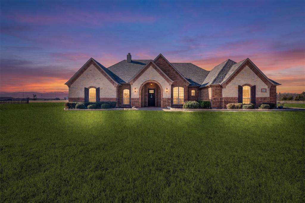 Stunning single-story custom home that has been meticulously maintained and shows like a model! Thoughtfully designed floor plan that feels much larger in person, featuring 4 bedrooms, 3 full baths, a formal dining room, and a spacious game room or second living room. Separate office with a closet can serve as a 5th bedroom. The main living room includes wood floors, a white stone fireplace, a shiplap feature wall, and an abundance of windows providing natural light.  Open floor plan with a gourmet kitchen showcasing an oversized island, stunning decorative lighting, built-in stainless-steel appliances, a double oven, ample cabinetry, granite countertops, and a huge walk-in pantry! The second living room is perfect for a children’s retreat, game room, or media room. Private primary bedroom with a sitting area and a gorgeous ensuite featuring dual vanities, a large walk-in shower, and a separate tub. Split-style secondary bedrooms each have walk-in closets. Laundry room includes a sink and built-in mudroom area. Covered rear porch perfect for relaxing and watching amazing sunsets!