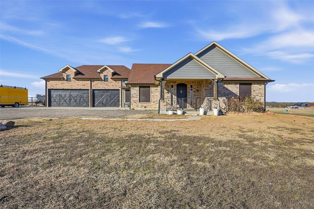 MOTIVATED SELLER!  Just minutes from town and outside city limits, with no deed restrictions or HOA.  This meticulous house is MOVE-IN-READY. Crown molding and ceramic tile consistent throughout the house.  NO CARPET.  Solid cedar wood cabinets, soft close drawers, and granite countertops compliment the kitchen.  All bedrooms have ceiling fans for those hot Texas summer days.  Primary en-suite has a jetted tub with separate shower.  Attractive 3-car garage with decor wood paneling your guests will envy, plus ample concrete parking for visitors.  Rain or shine, relax or entertain at the large covered back patio with ceiling fans. ADDITIONAL WING (900 sq ft not included in listing sq ft) added to the house with 2nd BR with en suite, plus 2 additional rooms.  One of the rooms is currently used for storage.  30 x 40 OUTBUILDING also comes with the property, with 12 x 40 covered porch.  Entrance to property has remote control sliding gate.  Dog house conveys. This property has so much to offer!!! Property is frontage to popular S. State Hwy 78, No Need to Drive on unpaved county roads. Did I mention, SELLER IS MOTIVATED!  Schedule a showing and make an offer today!!!