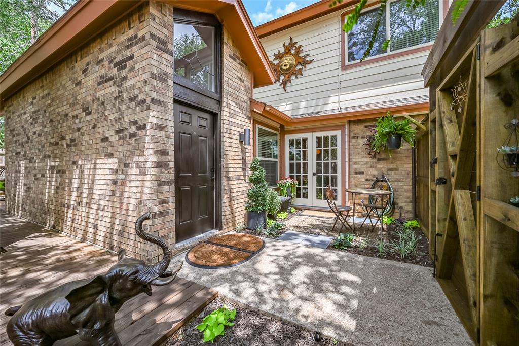 A thoughtfully crafted residence featuring custom design, comfort, and upscale practicality without the demands of excessive upkeep. Mature landscaping, established trees, a courtyard, patios, and shaded gathering spaces provide an inviting outdoor setting that feels open yet serene, ideal for pets, entertaining, and everyday enjoyment. A soaring wood-burning fireplace crowned by vaulted ceilings and anchored by an impressive marble fireplace establishes the home’s architectural character. Custom wood built-ins, crown molding, designer lighting, updated hardware, solid wood cabinetry, and distinctive finishes add warmth and character without sacrificing comfort or function. French doors extend the dining space outdoors, while new energy-efficient windows frame mature greenery, filtered sunlight, and leafy views throughout. Behind a built-in bookcase, a hidden room introduces an element of discovery while offering the flexibility to become whatever life requires next. The main-level primary suite continues the home’s sense of privacy, opening to a patio framed by mature trees and offering a walk-in closet and floor-to-ceiling spa-inspired shower. Upstairs bedrooms feature generous closets, new energy-efficient windows, abundant natural light, and crisp finishes that continue the home’s cohesive design. A customized powder bath with antique-inspired framing and a beveled bowl sink adds another
memorable detail. Major improvements include a new high-efficiency HVAC system, new energy-efficient doors, ceiling fans, updated lighting, and updated fixtures throughout. A one-car garage, off-street parking for up to four vehicles, and attic storage accessible from both the garage and second floor add practical everyday value. Move-in ready and fully realized, this home offers depth, adaptability, comfort, and
character already in place. The projects are finished. The possibilities are yours!