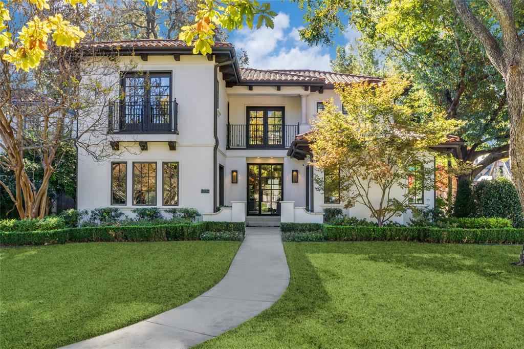 Nestled on a picturesque corner lot along Lakewood’s cherished Lakewood Boulevard, this Mediterranean-inspired masterpiece seamlessly blends timeless character with modern luxury. Built in 2011 and thoughtfully updated, this five-bedroom, five-and-a-half-bath home honors Lakewood’s rich heritage while offering today’s most desired amenities.

At over 5,000 square feet, every detail has been artfully designed for comfort, style, and connection. The welcoming entry flows into elegant living spaces anchored by two fireplaces that cast a warm glow in both the study and main living area. The spacious dining room sets the stage for dinner parties and special occasions, while the expansive kitchen serves as the heart of the home—with a generous center island, professional-grade appliances, and a breakfast bar that opens to the light-filled breakfast nook and family room.

Walls of windows frame lush landscaping and invite you to enjoy the outdoors year-round from two large covered porches—perfect for relaxing evenings or lively gatherings. The first floor also includes a private guest suite with a full bath, a stylish powder room, and a four-car attached garage.

Upstairs, three secondary bedrooms each enjoy their own en-suite bathrooms, complemented by a versatile second living space that opens to another outdoor retreat. The laundry room is conveniently located upstairs for ease of living. The primary suite is a private sanctuary—graciously proportioned with a spa-inspired bath featuring dual vanities, a soaking tub, a walk-in shower, and a generously sized walk-in closet.

Distinguished yet inviting, this home offers a rare blend of architectural beauty, functionality, and charm. Move-in ready and meticulously cared for, it captures the essence of Lakewood living—vibrant, elegant, and perfectly placed in one of the city’s most coveted neighborhoods.