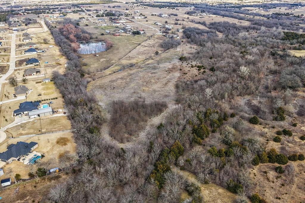 Tucked away at the end of a quiet cul-de-sac, this 21.72-acre tract offers the perfect blend of privacy, flexibility, and opportunity. The property can be enjoyed as one expansive homesite or subdivided into two parcels of approximately 10 acres and 11.72 acres, ideal for multigenerational living, investment, or future development.

Featuring a scenic pond, existing barn, mobile home, and fencing, the land is already equipped with valuable improvements while still offering a blank canvas to bring your vision to life. Located in the ETJ, you’ll benefit from added flexibility with fewer restrictions while still being within reach of nearby city conveniences.

Whether you’re looking to build your dream home, create a private retreat, or develop a new project, this property presents endless possibilities in a peaceful, secluded setting.