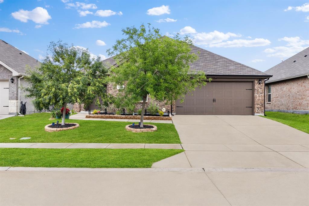 Ideally positioned within Stonewyck Farms, one of Ennis' most desirable newer communities, this better-than-new residence offers an exceptional blend of style, comfort, and value. Step inside to a light-filled, open-concept floor plan where the seamless flow between the living, dining, and kitchen areas creates an atmosphere that feels both expansive and welcoming - perfect for entertaining guests or enjoying everyday life. At the heart of the home, the beautifully appointed kitchen impresses with abundant cabinetry, generous counter space, a refrigerator for added value and convenience, and a large center island that naturally becomes the gathering place for family and friends. Privately tucked away from the secondary bedrooms, the spacious primary suite serves as a peaceful retreat, complete with an oversized walk-in shower and dual walk-in closets. Thoughtfully designed for both comfort and functionality, the secondary bedrooms are generously sized and share a well-appointed full bath. Outdoors, the large, covered patio extends the living space and overlooks a private backyard with endless possibilities - whether you envision weekend barbecues, a play area, lush gardens, or your own personal outdoor oasis. Adding even more value, qualified buyers may have the opportunity to assume the existing 4.99% interest rate, a rare financing advantage in today's market. Conveniently located near local schools, shopping, dining, and Interstate 45, this exceptional home offers the perfect balance of small-town charm and modern convenience, with Lake Bardwell and a variety of recreational destinations just minutes away.