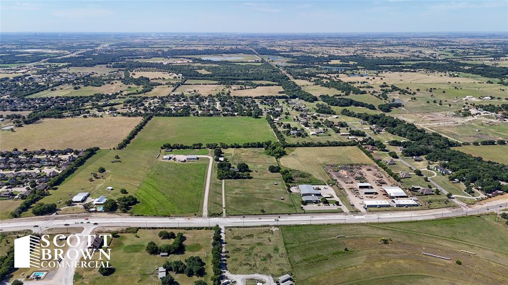 This property is rectangular in shape with a wood frame house, detached garage, and a small barn structure.