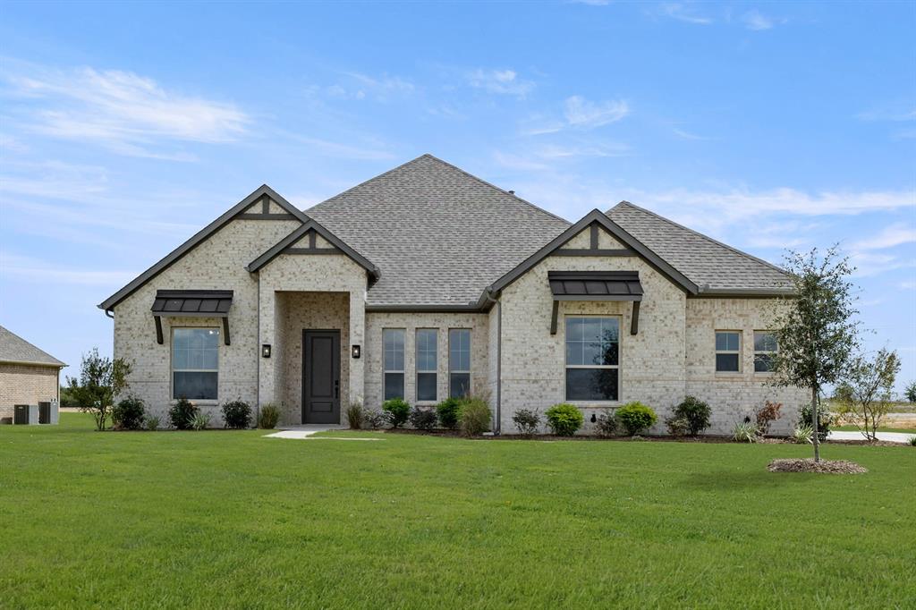 MLS# 21296284 - Built by Sandlin Homes - Ready Now! ~ Welcome to the Bellaire plan – a thoughtfully designed home offering 4 spacious bedrooms, 3 bathrooms, a private study, and an expansive open-concept living area. Perfect for entertaining or everyday living – the kitchen seamlessly connects to the great room and dining area, providing both function and flow.    Enjoy elegant quartz countertops paired with crisp white upper cabinets and medium gray stained base cabinets for a sophisticated contrast, along with the stunning backsplash tile to add a modern flair. Durable laminate flooring runs throughout, complemented by the adorned bath tiles, and textured utility flooring. The centerpiece of the great room is the beautifully tiled fireplace with wood paneling, creating a warm and stylish focal point.