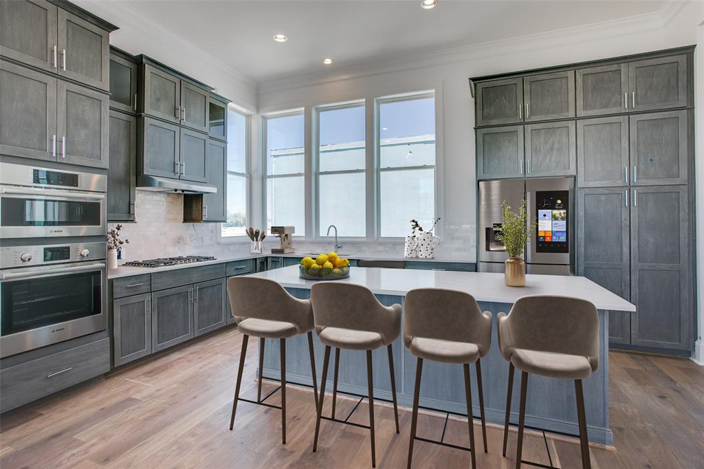 PRICE IMPROVEMENT + 3% FLEX CASH INCENTIVE toward upgrades, closing costs, or rate buydowns. Welcome to Foundry Row, an exclusive collection of 8 townhomes in Fort Worth’s vibrant West 7th District. This elegantly designed END UNIT features an open floorplan with high-end finishes ideal for entertaining. The main level boasts soaring 12-foot ceilings and a 10-foot sliding glass door that seamlessly extends your living space outdoors. The gourmet kitchen is equipped with Bosch stainless steel appliances, quartz countertops, a stylish tile backsplash, and soft-close cabinetry. The serene primary suite includes a large drop-in tub, walk-in shower, and extra spacious closet. Throughout the home, upgraded engineered hardwoods enhance the sophisticated ambiance, while the private rooftop deck offers a quiet retreat with sweeping views of Downtown Fort Worth. Located just minutes from the lively West 7th District, you’ll enjoy convenient access to dining, shopping, museums, entertainment, and more. Experience the perfect blend of luxury and sustainability in this exceptional home. PLEASE GO TO MODEL HOME FOR ALL OPEN HOUSES - 201 CARROLL ST.