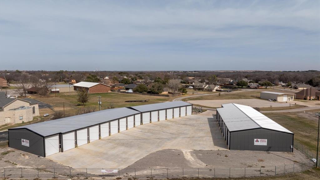 **Your Next Investment Opportunity Awaits in Granbury** Welcome to a brand-new, turnkey storage unit complex that's ready to generate revenue from day one. This newly constructed commercial property sits on the bustling Fort Worth side of town, enjoying prime placement along one of the area's most heavily traveled corridors. With excellent visibility and constant traffic flow, this location practically markets itself. The complex features 27 thoughtfully designed, fully insulated units built to accommodate a wide range of storage needs. The unit mix includes eighteen spacious 50-foot units, seven versatile 45-foot units, and two 40-foot units, offering tenants plenty of options for everything from personal belongings to boats, recreational vehicles, and commercial equipment. Insulated construction ensures climate resilience, adding a premium touch that today's renters actively seek out. What truly sets this property apart is its fully automated leasing and entry system. Clients can sign leases, make payments, and access their units without the need for on-site staff, keeping operational overhead refreshingly low. Think of it as a business that practically runs itself while you sleep! Granbury continues to experience steady growth, and demand for quality storage solutions shows no signs of slowing down. This investment offers a rare combination of new construction, smart technology, high-traffic location, and a proven business model wrapped into one compelling package. Do not let this opportunity pass you by. Schedule your private tour today and see why this property deserves a place in your portfolio.