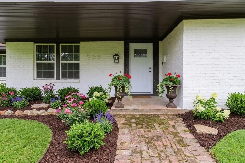 MID-CENTURY CHARM ON 1.31 ACRES IN LUFKIN! 3 Beds – 2.5 Baths – Vaulted Ceilings – Open Kitchen – Sunroom – Covered Courtyard — This beautifully refreshed ranch-style home offers 3,302 sq ft of living space on a private tree-lined lot. Inside you'll find wood-look flooring, a dramatic floor-to-ceiling brick fireplace, vaulted ceilings, and a spacious open-concept layout. The kitchen features a large island, electric cooktop, abundant cabinetry, and a bright dining area. A dedicated office and enclosed sunroom provide flexible space for work or relaxation. The primary suite includes a custom walk-in closet, soaking tub, and modern walk-in shower. Outside, enjoy a covered brick courtyard patio overlooking the expansive fenced backyard. Complete with a 2-car garage, storage rooms, and detached shed, this property offers the perfect blend of space, privacy, and modern updates just minutes from shopping, dining, and medical facilities.