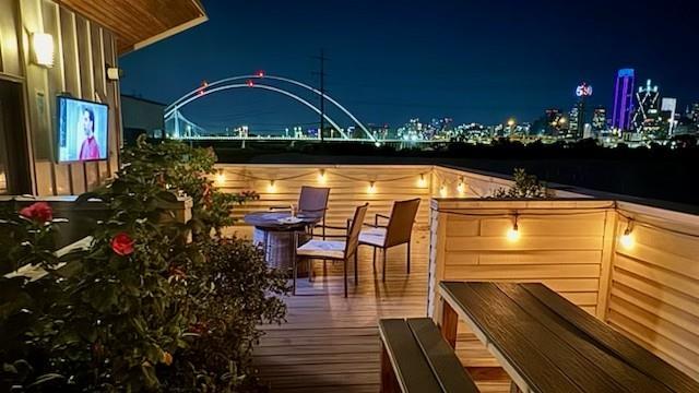 Corner-unit townhome featuring a rooftop terrace with breathtaking downtown skyline views. This stylish, contemporary home showcases a sleek exterior design and is ideally located just minutes from Bishop Arts, Trinity Groves, and Downtown. Step inside to soaring 10–11 ft ceilings, a custom staircase, 2-car garage, and a first-floor guest suite with a private backyard.

The second level offers an expansive living area with floor-to-ceiling windows, a gas fireplace, and a private balcony, seamlessly connecting to a stunning chef’s kitchen. The kitchen is equipped with stainless steel appliances, custom cabinetry, a large island with breakfast bar seating, white quartz countertops, and a spacious dining area.

The generous primary suite includes a walk-in closet, dual vanities, a jetted tub, and an oversized shower. A dedicated study off the primary suite can easily serve as a third bedroom or nursery. A full-size laundry room is conveniently located on the same level as the primary suite.

The fourth-floor rooftop deck is expansive and offers unobstructed, panoramic views of downtown. Low HOA fees and community pool!