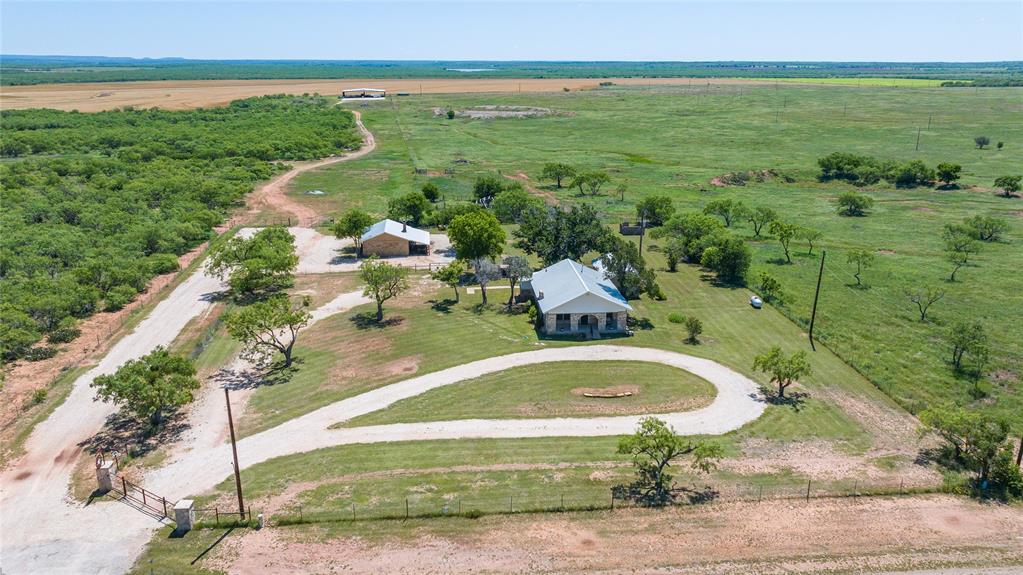 Escape to wide-open West Texas living with this exceptional 535-acre ranch in South Taylor County. Offering a rare combination of productive farmland, recreational appeal, and thoughtfully updated improvements, this property is perfectly suited for ranching, farming, hunting, or a private country retreat. Approximately 300 acres are currently in cultivation, while the remaining acreage provides excellent grazing and recreational opportunities. The property is fenced and cross-fenced for livestock management and includes two small wheat fields that are currently being grazed by sheep. Buffalo Creek winds through the ranch, complemented by several tanks that provide excellent water resources for livestock and wildlife alike. Improvements include a massive 90x120 open-air barn with electricity, ideal for equipment storage, hay, or livestock operations, along with a 52,000-gallon water storage holding tank. The completely updated 1926 farmhouse that will be sold furnished, blends timeless character with modern comfort, creating a warm and inviting home in the heart of the ranch. Just behind the home, you’ll find a versatile forge-workshop featuring spray foam insulation, electricity, and a half bath — perfect for projects, hobbies, or additional workspace. With scenic views, abundant water features, productive acreage, and quality improvements, this South Taylor County ranch offers endless possibilities. Minerals are negotiable.
*Farm Equipment is also for sale*