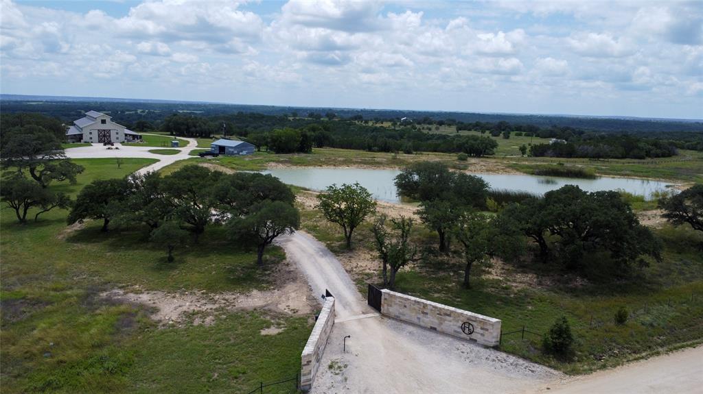 Nestled along 1,600’ of Leon River frontage, this 214±-acre Luxury Hill Country estate features varied terrain, four ponds, seasonal creeks, a river-bottom pecan grove and abundant deer, turkey and wildlife. Cross-fenced for rotational grazing with cattle pens and Large Workshop with Overhangs and RV Hook up, covered equipment bays, it offers prime fishing, hiking and ATV trails. The 10,000-SF lodge boasts a 2,500-SF glass-front great room, gourmet chef’s kitchen with Wolf appliances, three master ensuites, dual laundries, a second-floor retreat with kitchen and office, plus indoor-outdoor bar area, 8,200 SF of porches. Ten solar-powered cabins provide refined guest lodging. A comprehensive solar array powers every building. Just outside Gatesville—at the midpoint between Austin and the DFW Metroplex—this turnkey Luxurious river-front ranch is ideal as a multigenerational retreat, executive getaway or legacy sporting property.